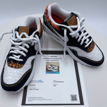 Pair of sneakers with a certificate of authenticity on a white background