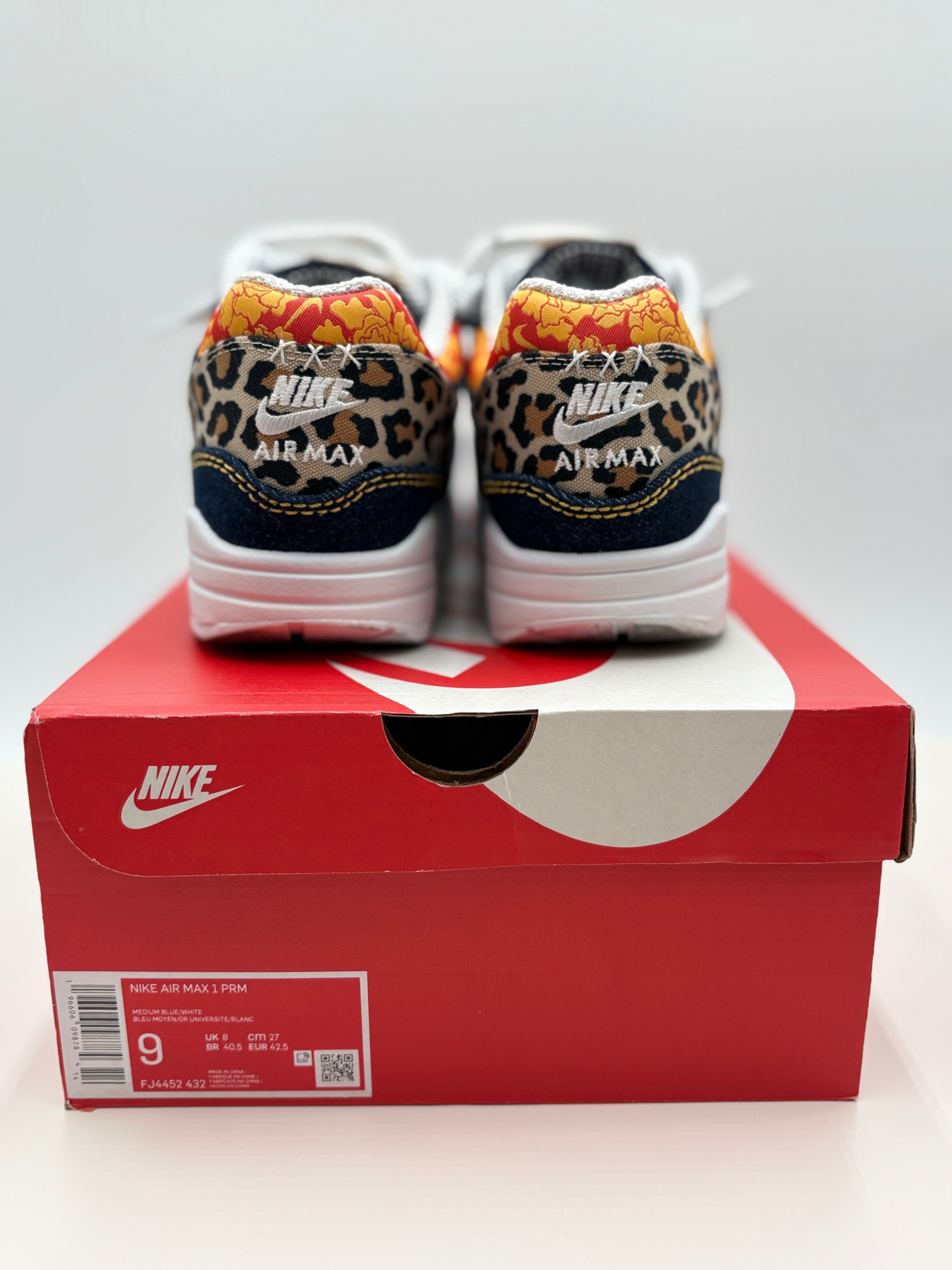 Leopard print sneakers on a red Nike box with a white background
