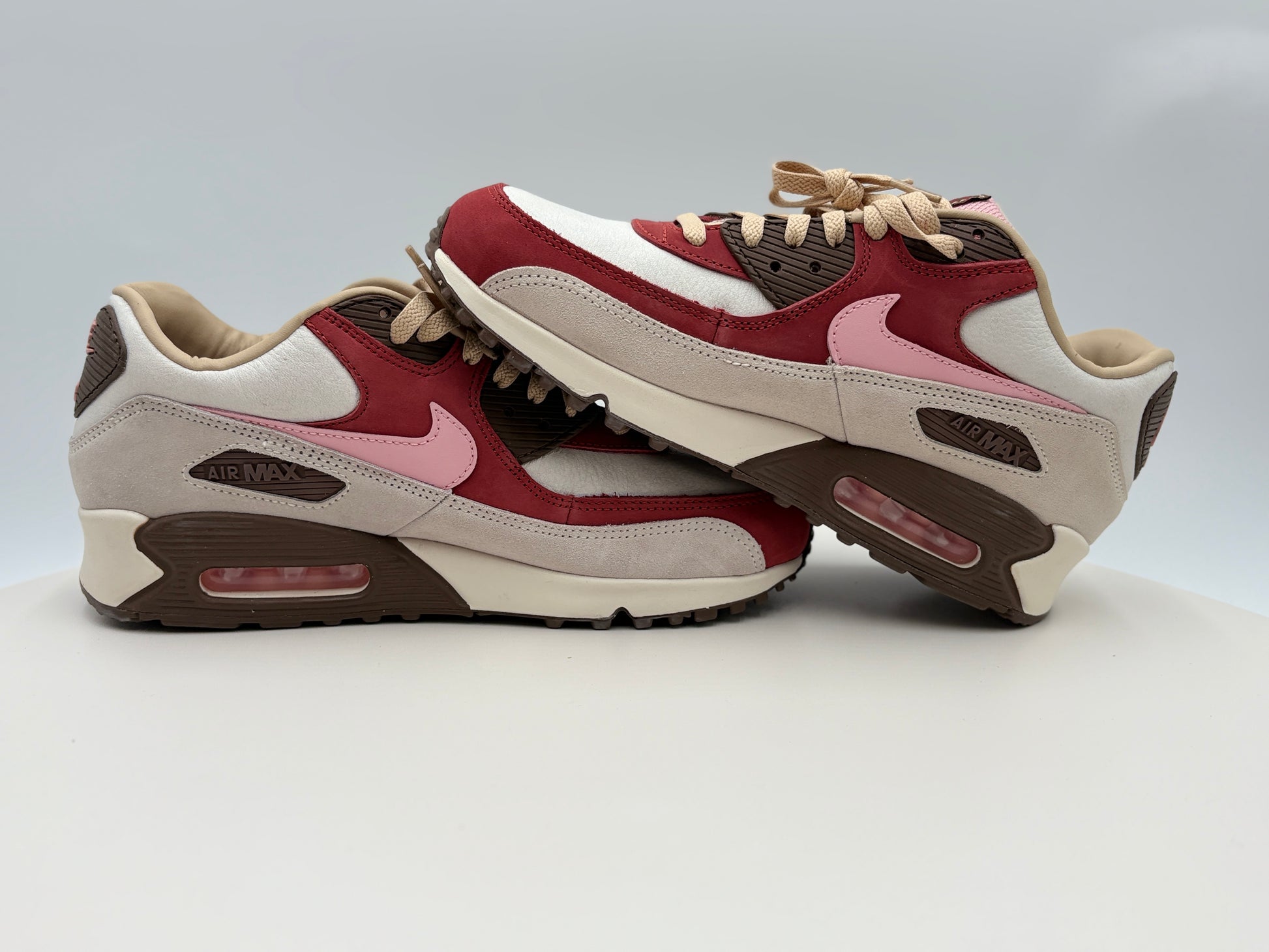 Pair of Nike Air Max 90 DQM ‚ÄúBacon‚Äù (CU1816-100)  pink and beige sneakers on a white background