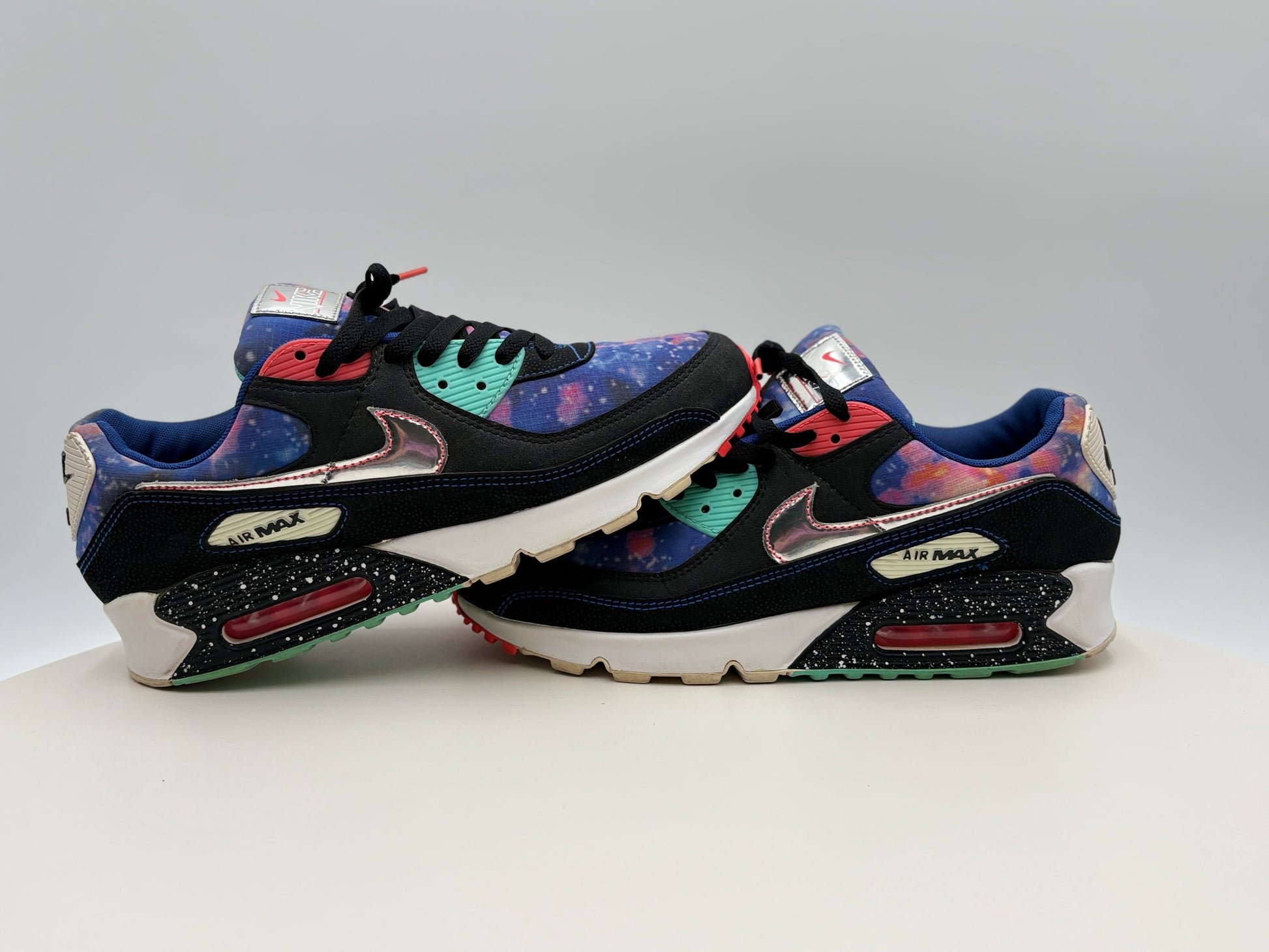 Colorful sneakers with a brand logo on a light gray background