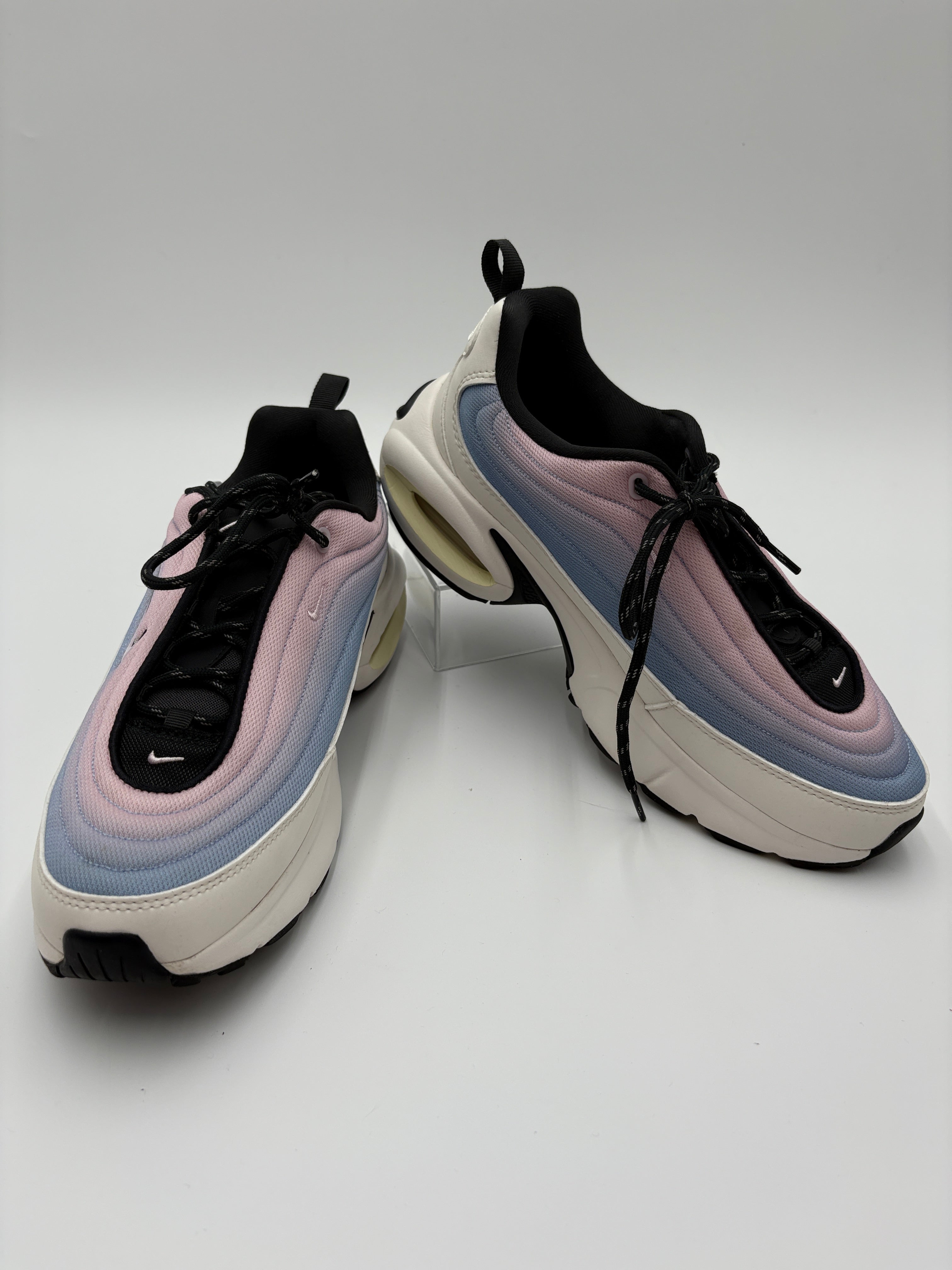 Pair of multicolored sneakers on a light gray background