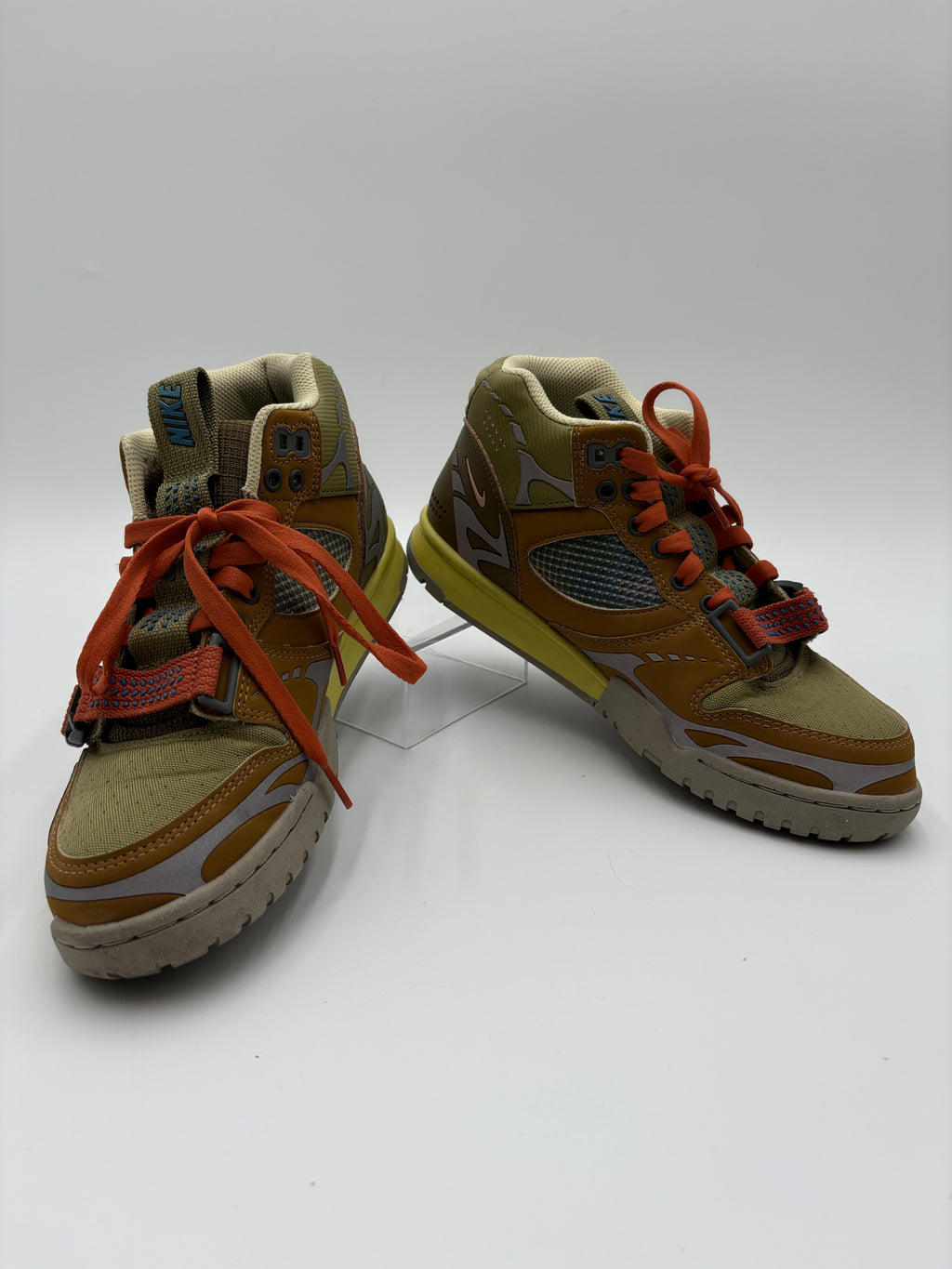 Pair of tan and orange sneakers on a white background