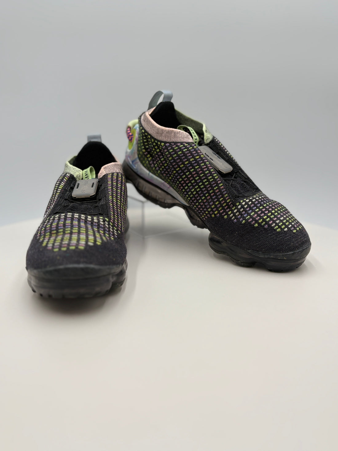 Black athletic shoes with a certificate of authenticity on a white background