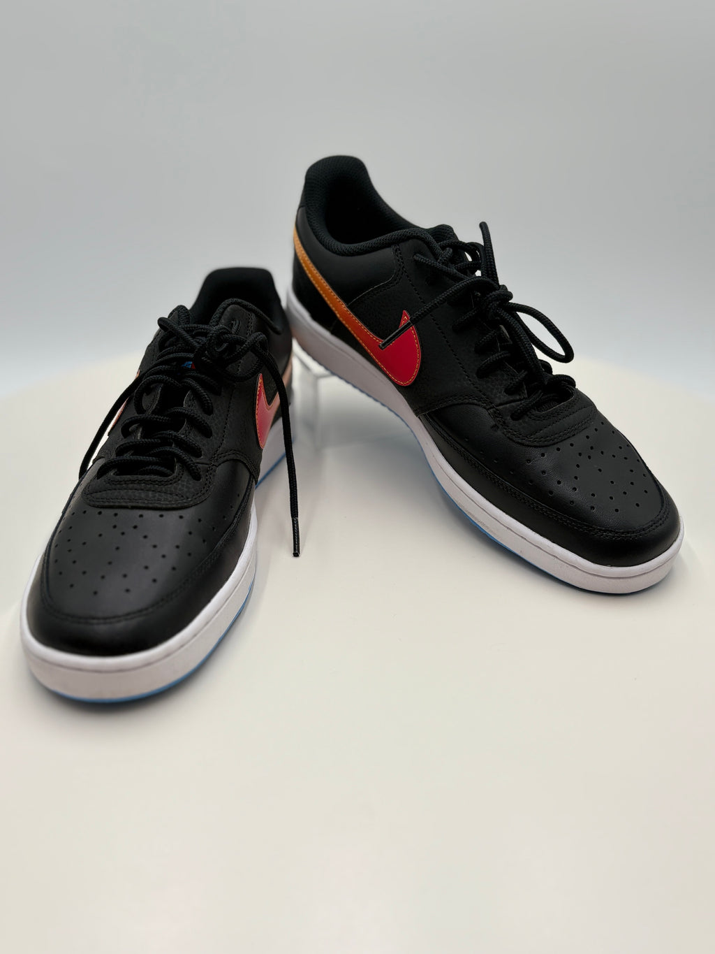 Black sneakers with red accents on a white background