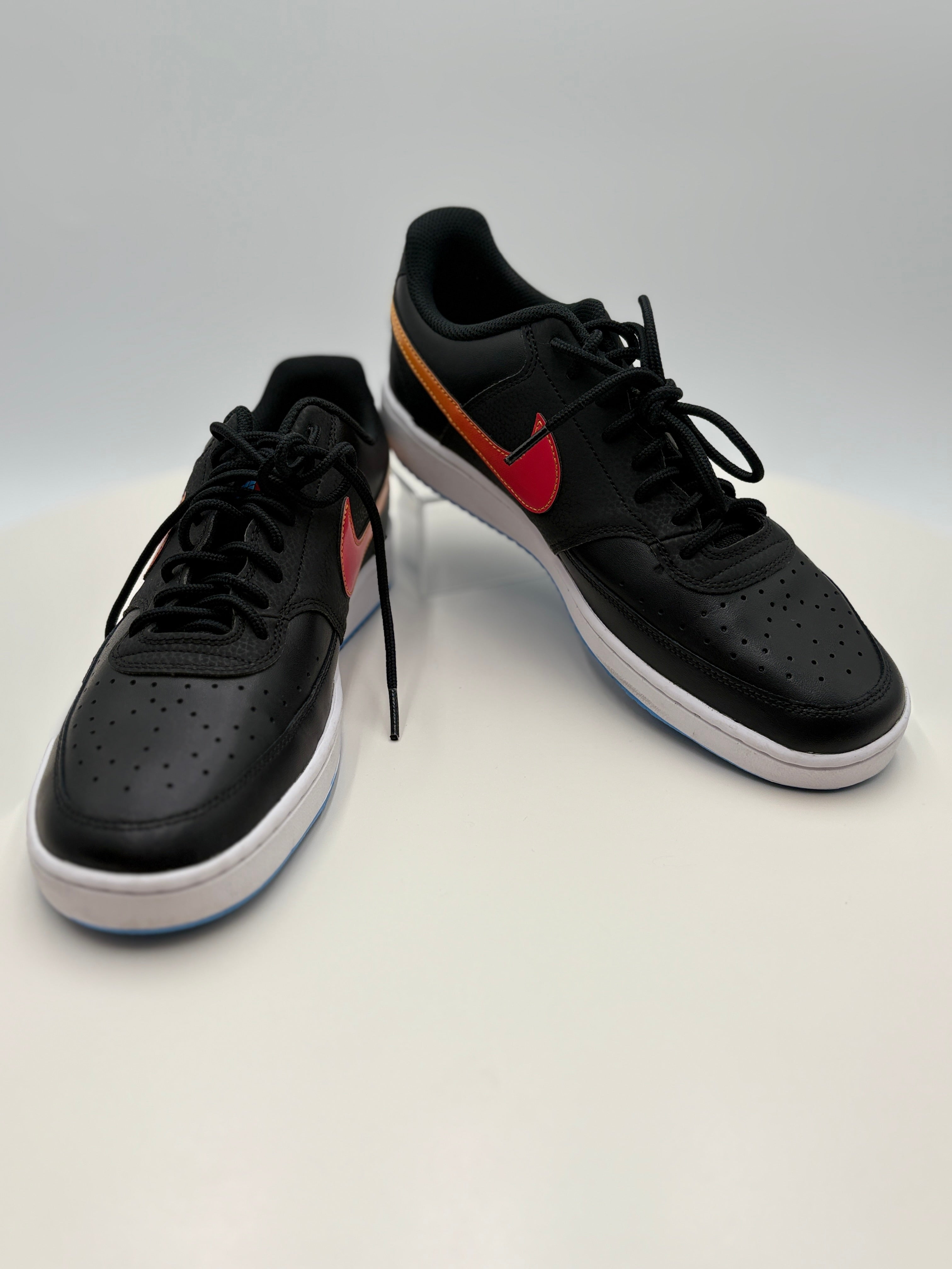 Black sneakers with red accents on a white background