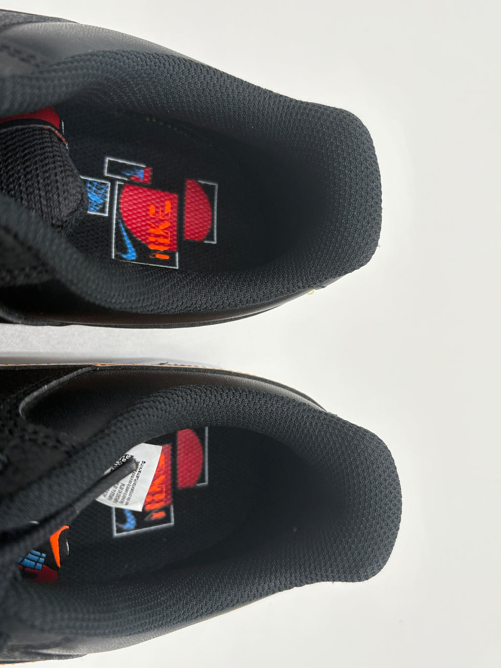 Black sneakers with colorful logo on a white background