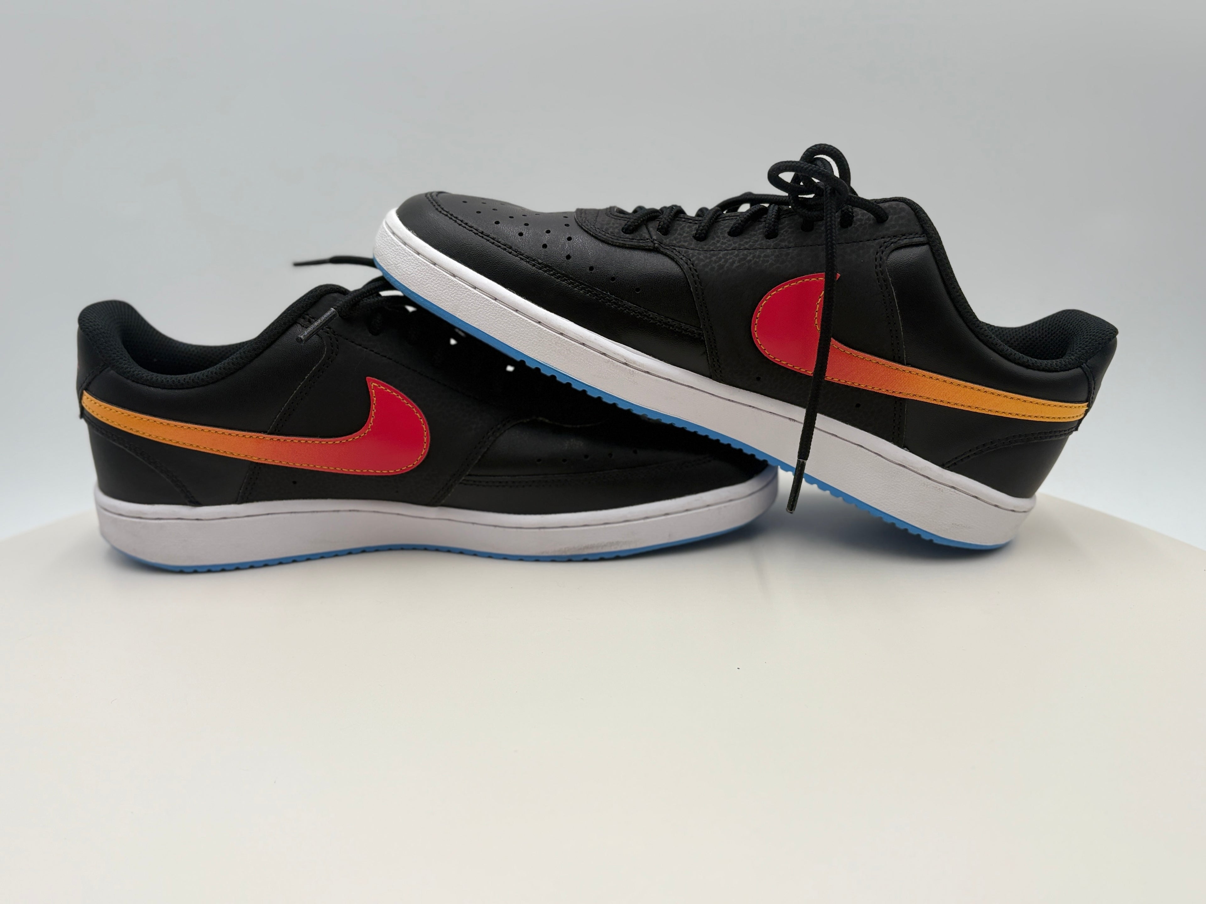 Black sneakers with colorful accents on a white background