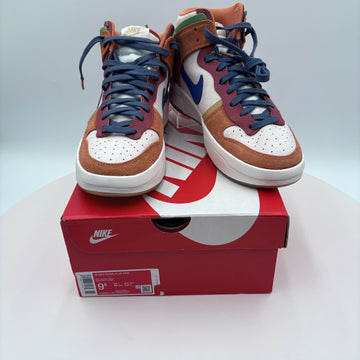 Pair of high-top sneakers with brown, white, and blue design on a red Nike box.