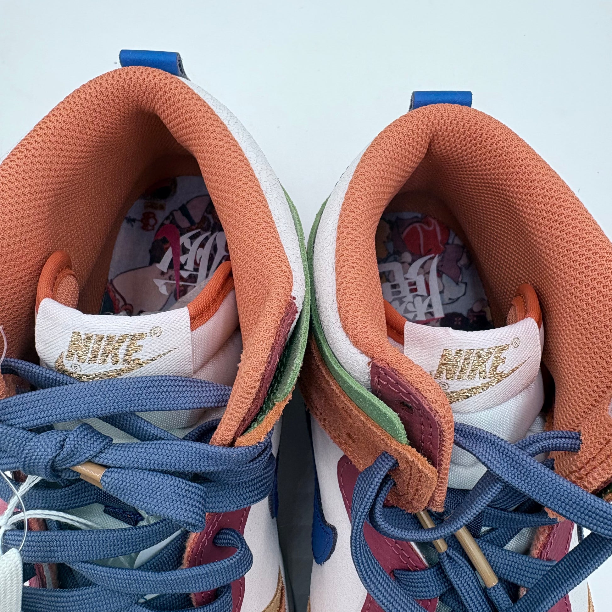 Close-up of a pair of Nike sneakers with colorful laces and sole.