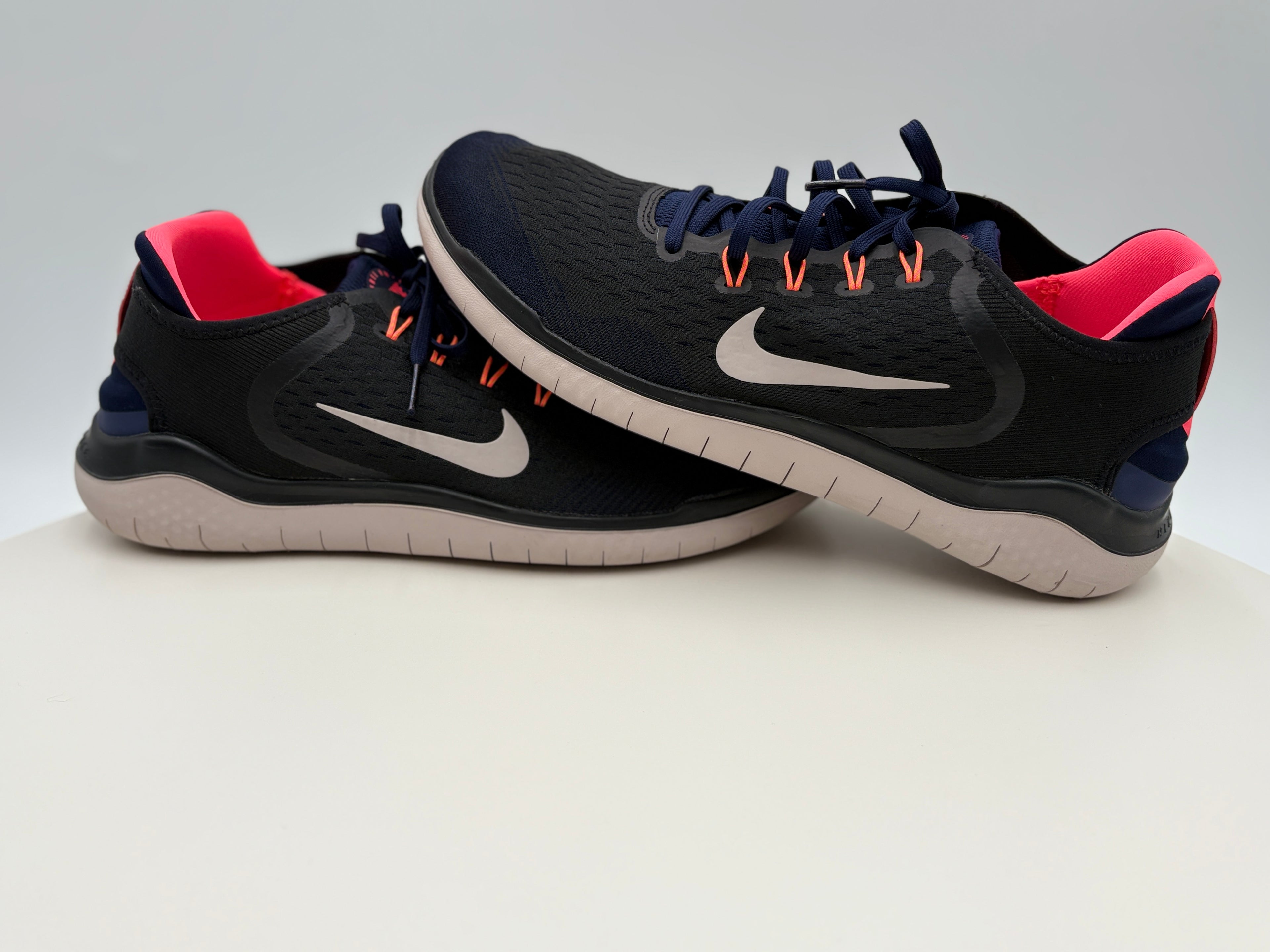 Black and red Nike running shoes on a white background