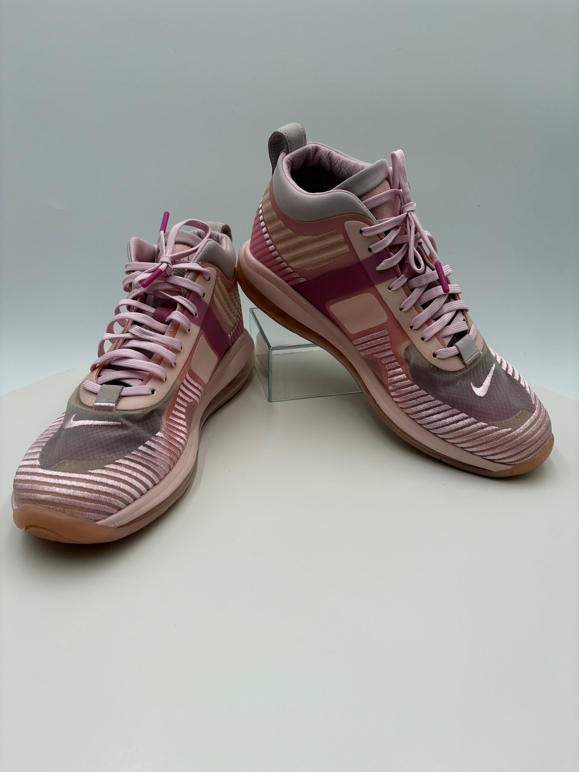 Pair of pink and gray sneakers on a light gray background
