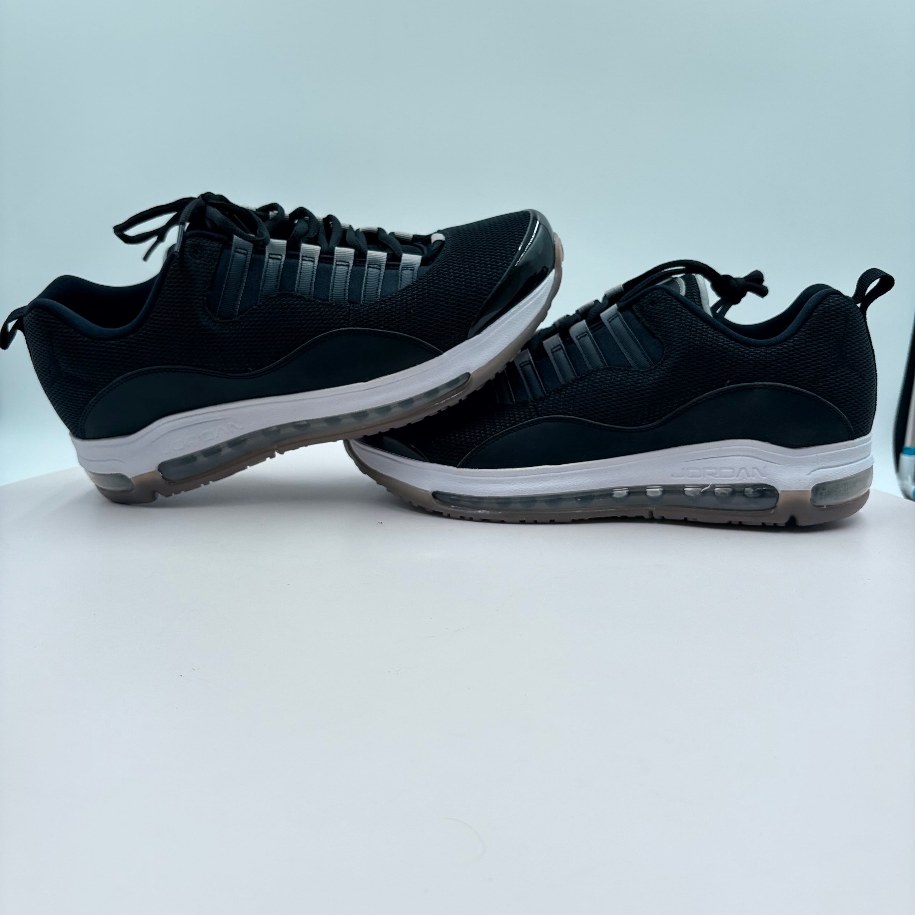 Black sneakers with white soles on a light gray background