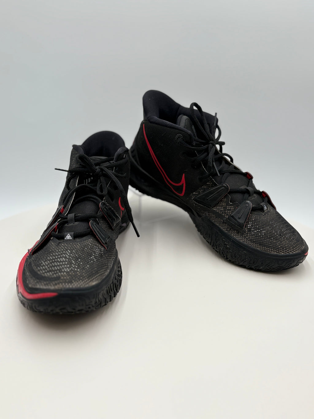 Black sneakers with red accents on a white background