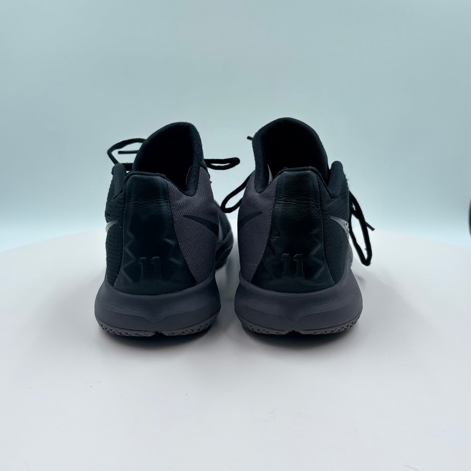 Black sneakers on a light gray background