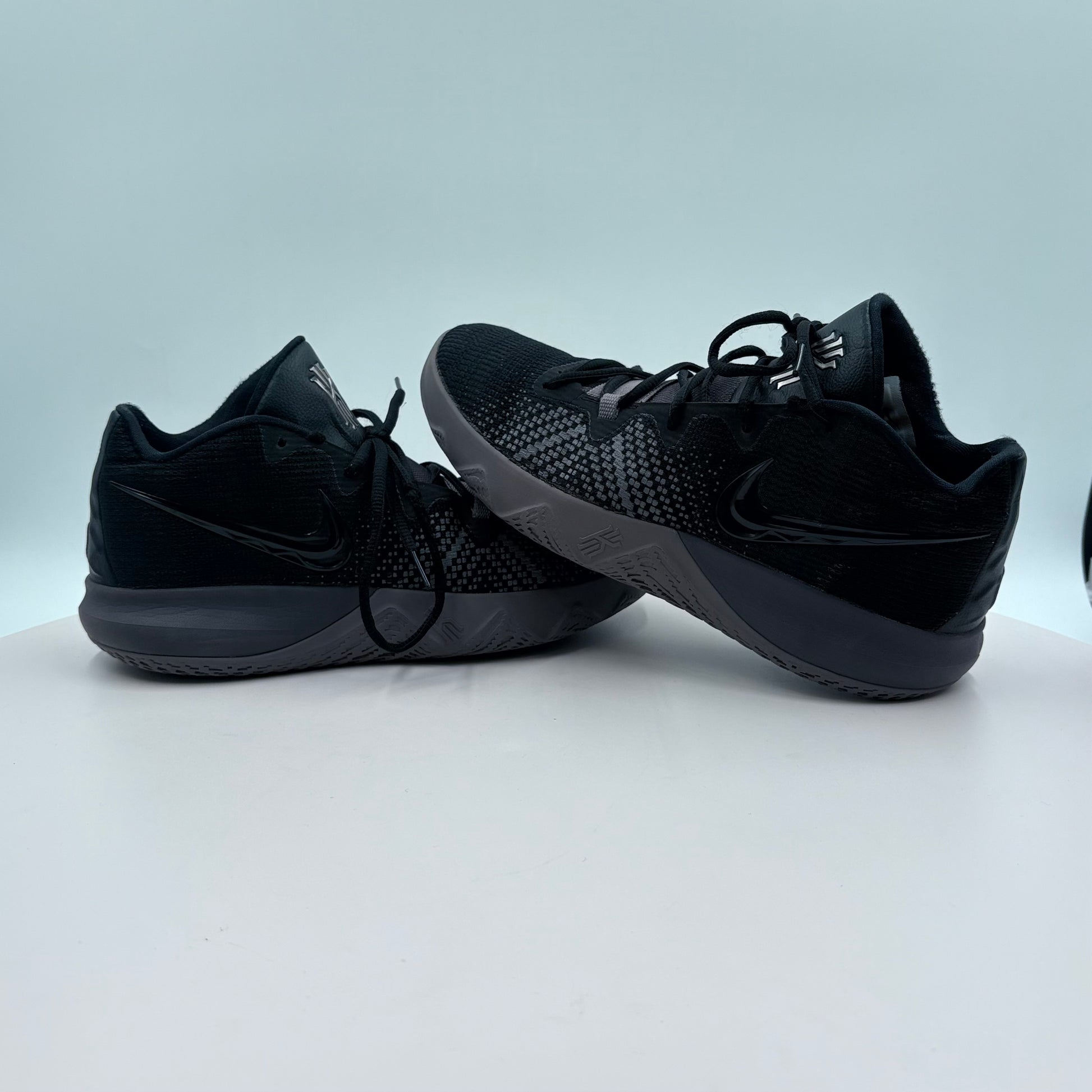 Pair of black sneakers on a light gray background