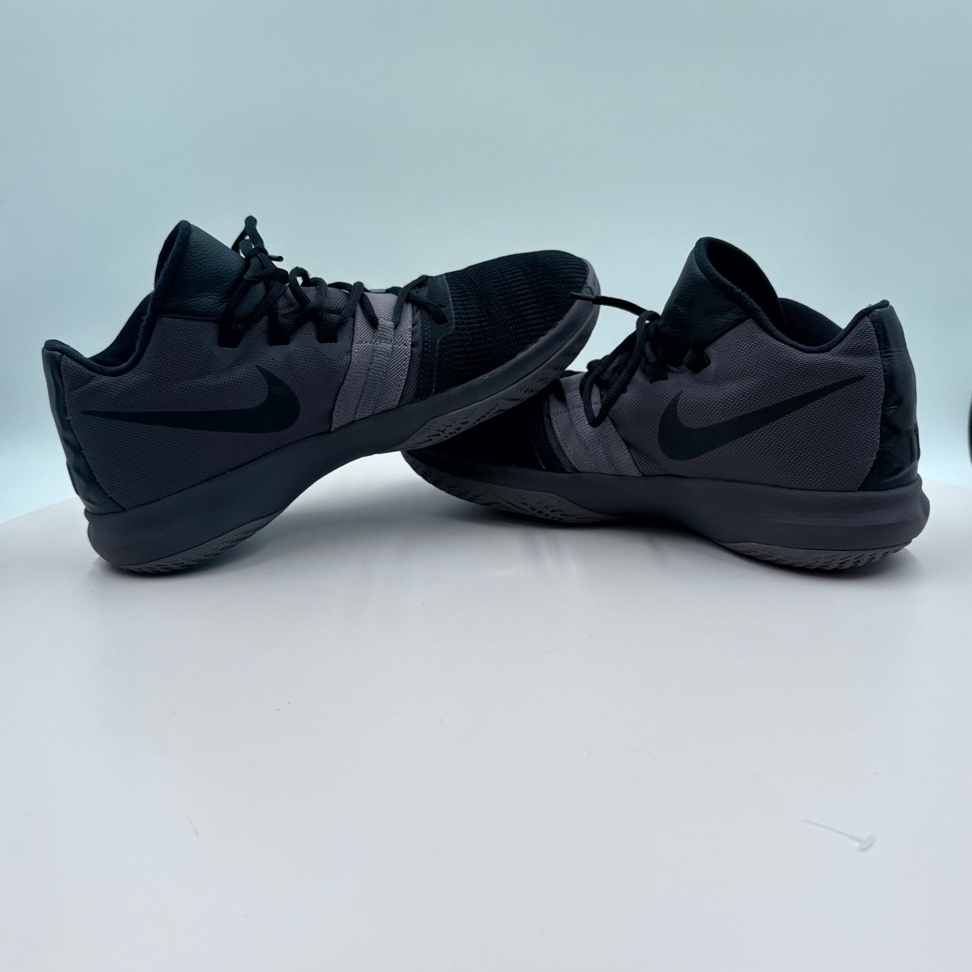 Pair of black Nike sneakers on a light gray background