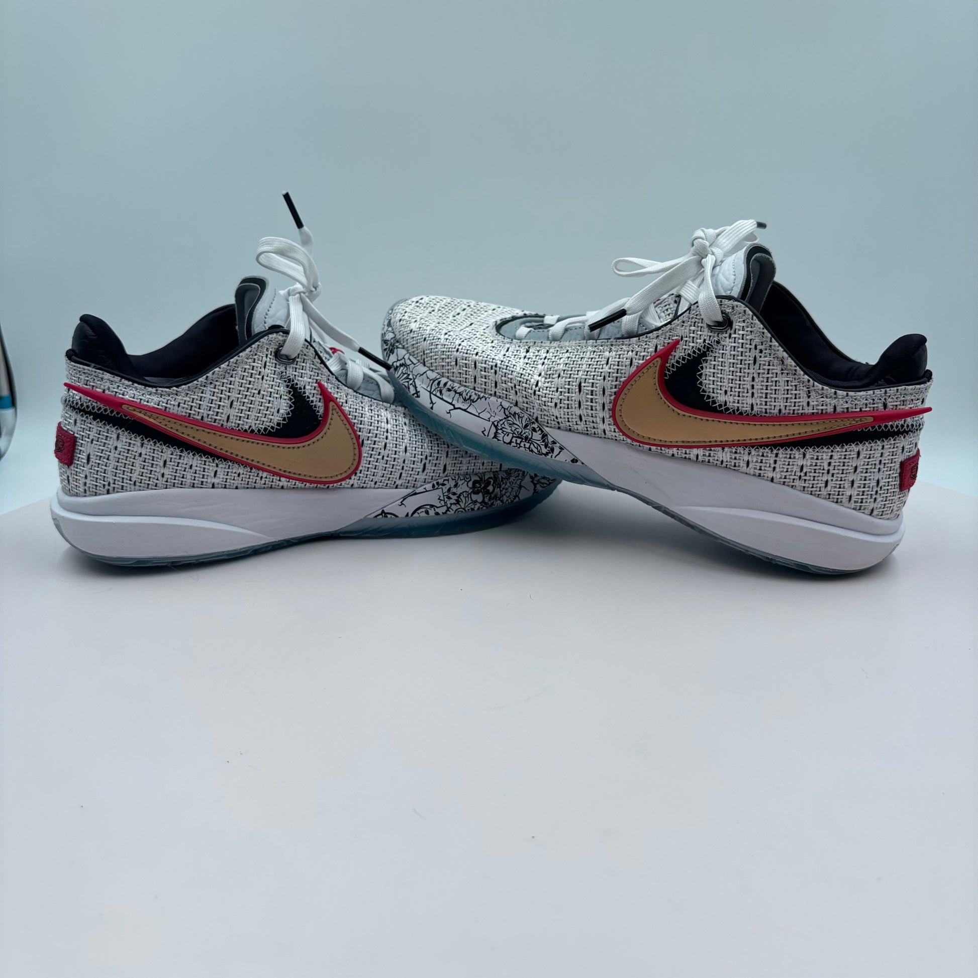 Pair of Nike shoes with a speckled pattern on a light gray background