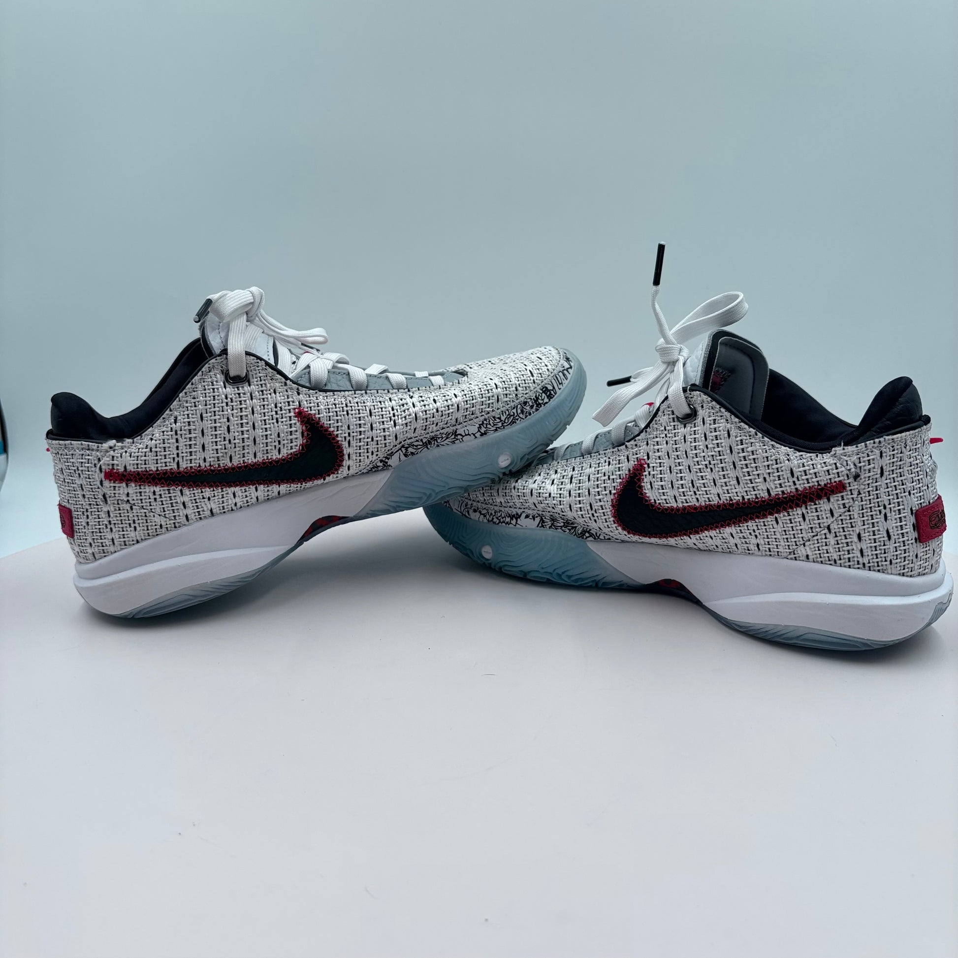 Pair of Nike sneakers with a patterned design on a light gray background