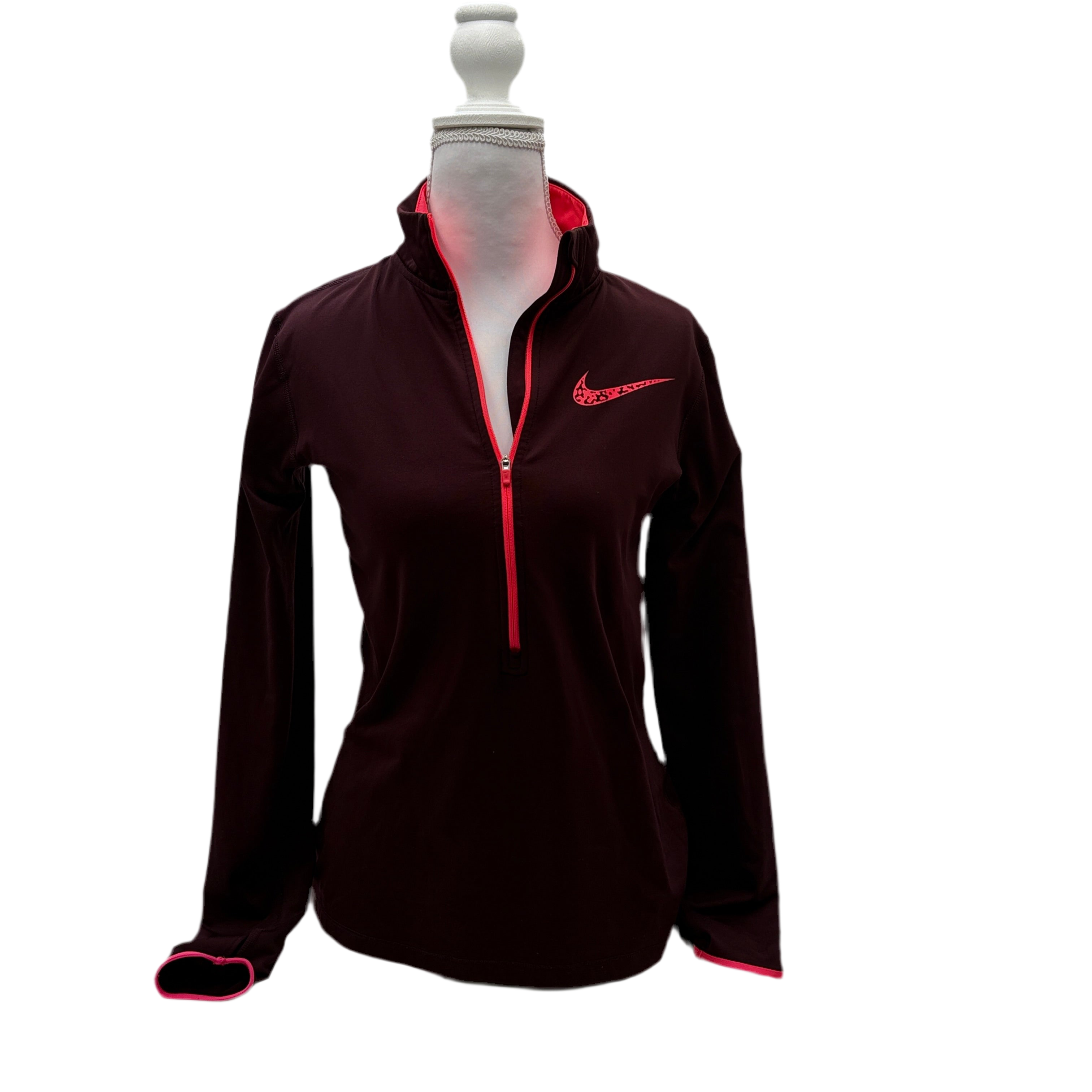 Black long-sleeve athletic jacket with red accents on a mannequin against a white background