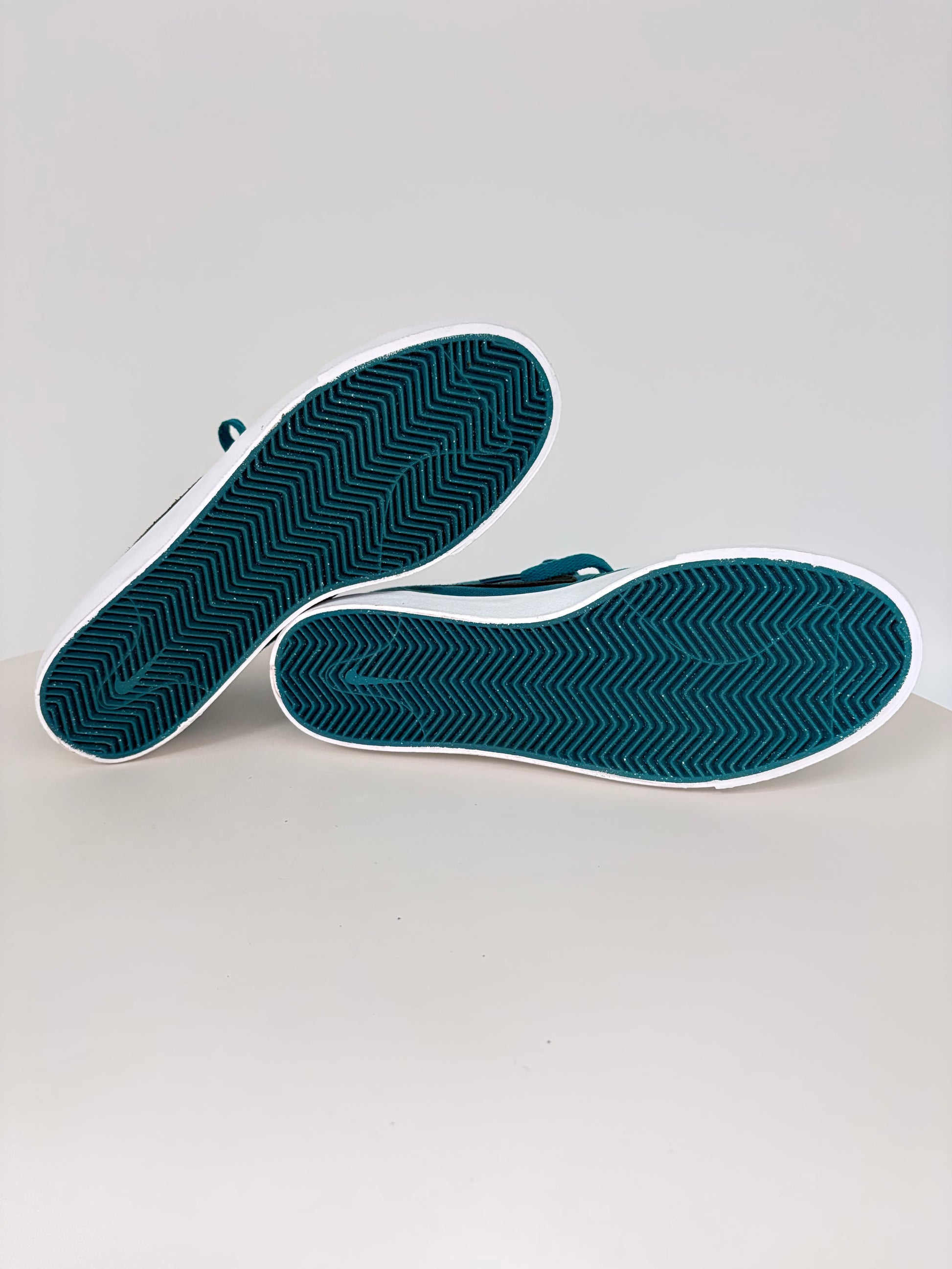 Pair of blue shoe insoles on a light gray background