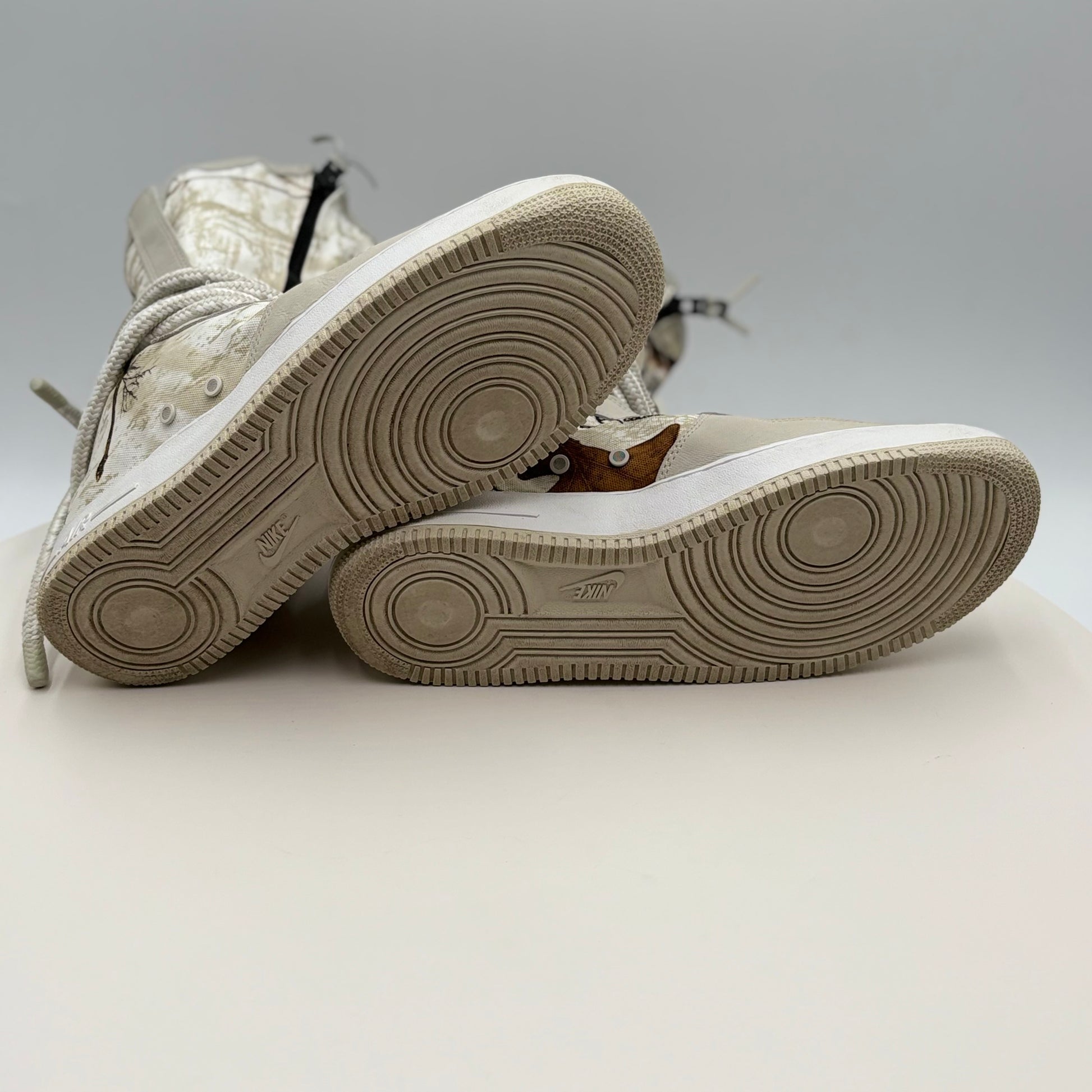 White sneakers with beige soles on a light gray background