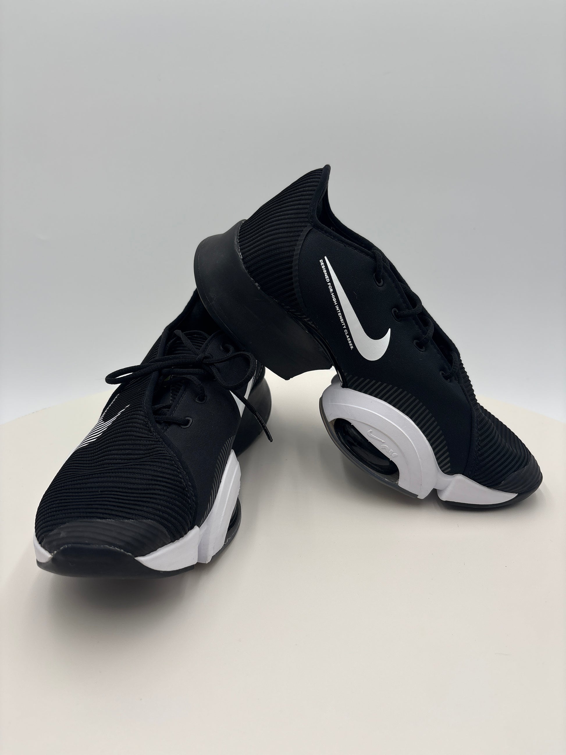 Black and white Nike sneakers on a light gray background
