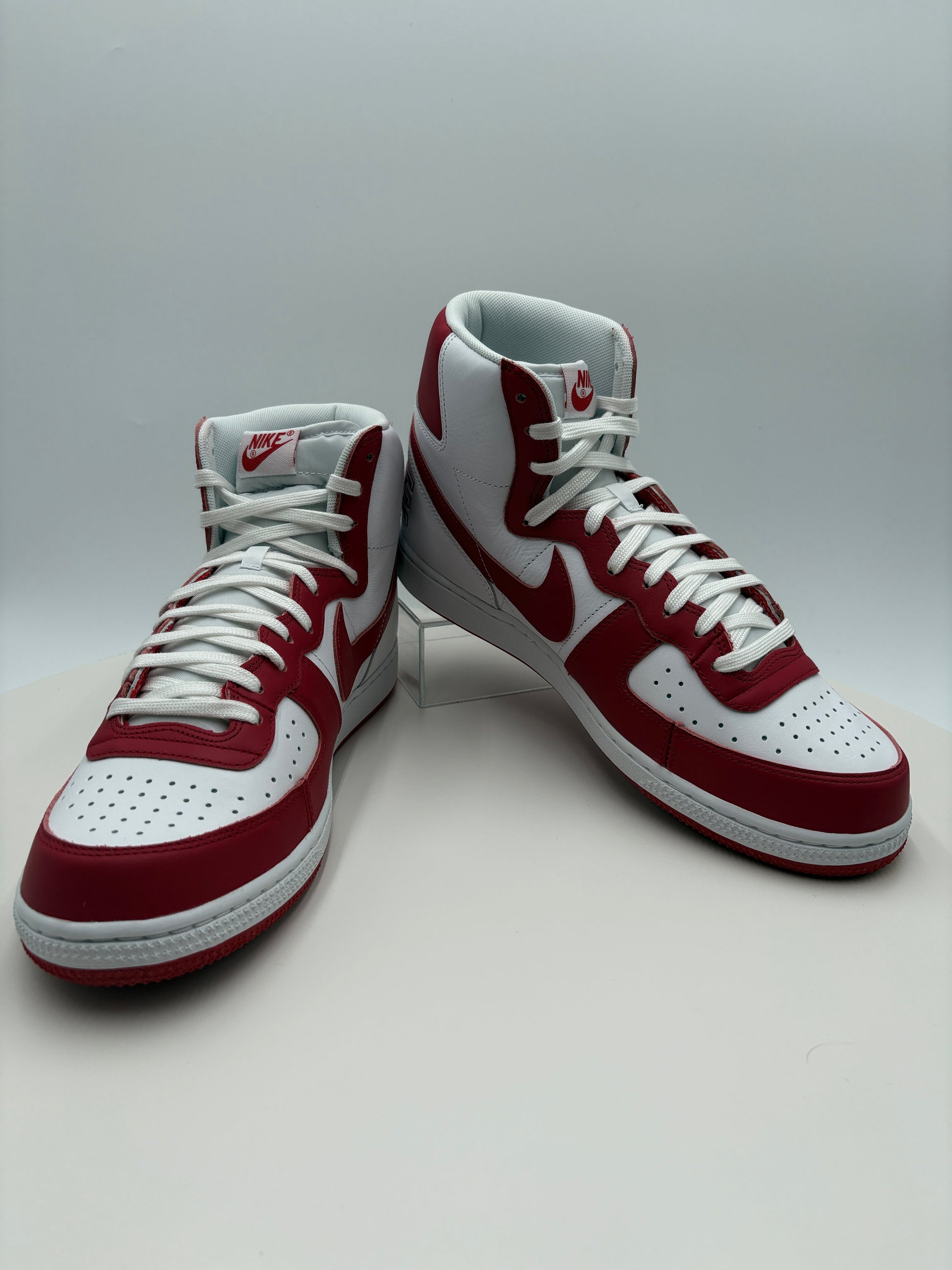 White and red sneakers on a light gray background