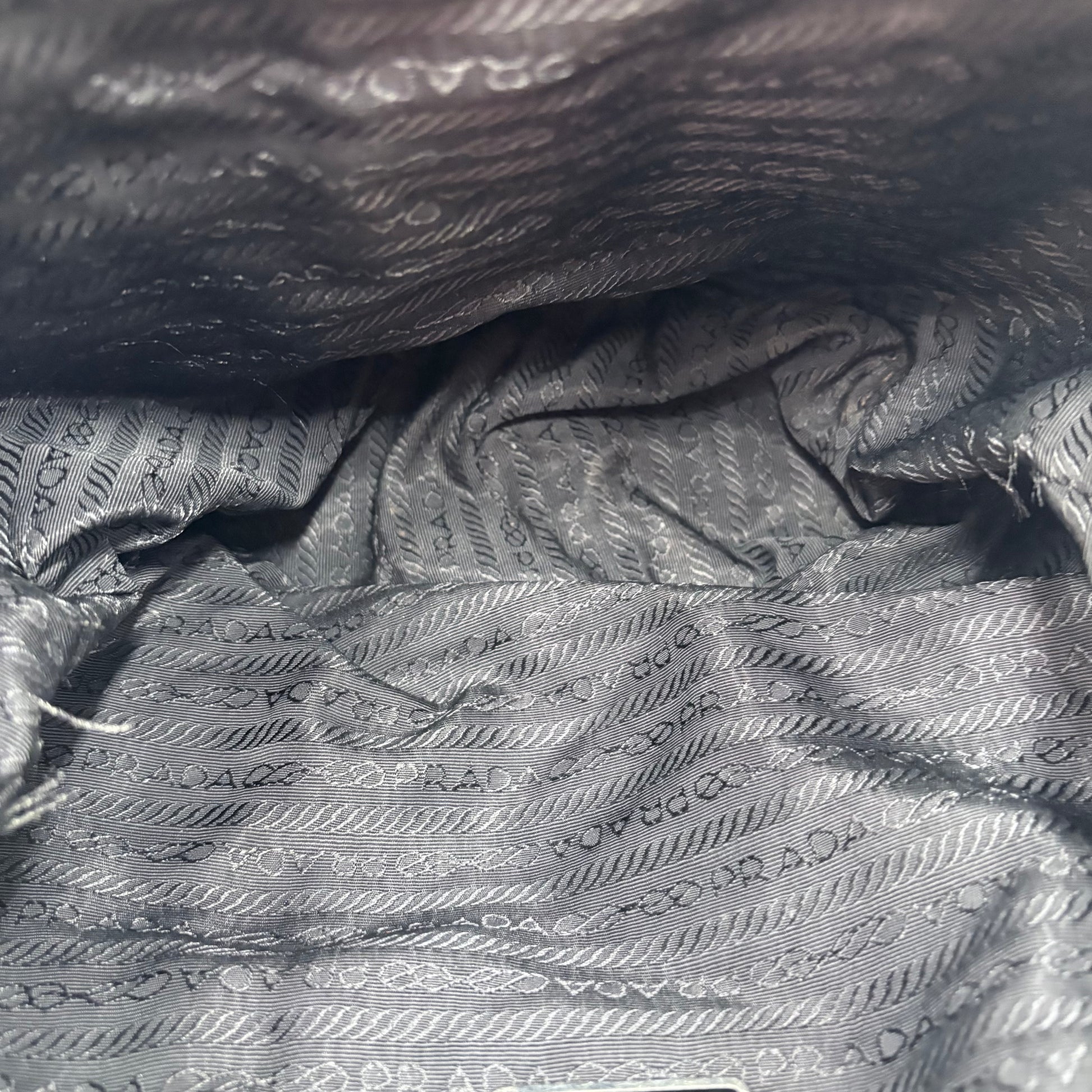 Close-up of Prada branded gray fabric with subtle pattern