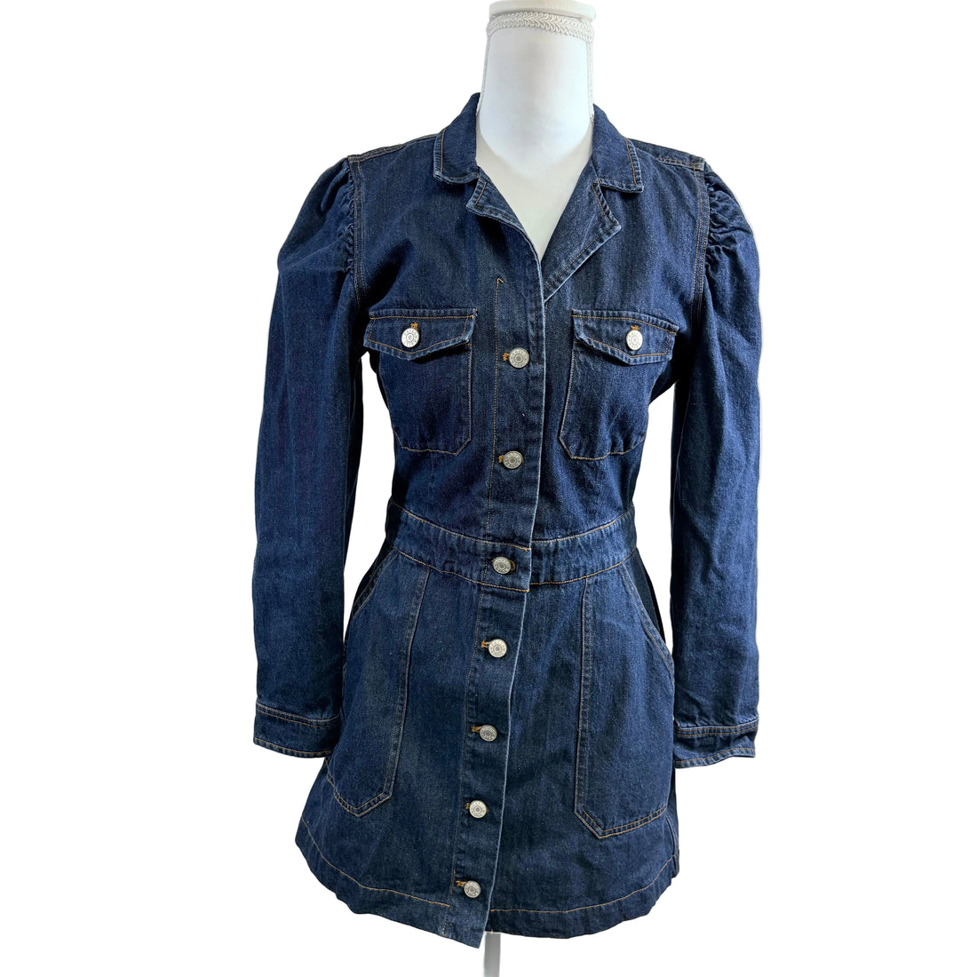 Blue denim dress on a mannequin against a white background