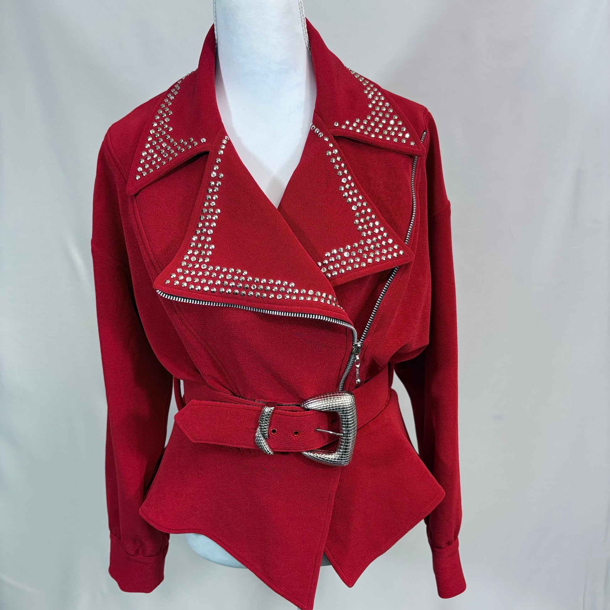 Red jacket with studded details and a belt on a mannequin against a white background