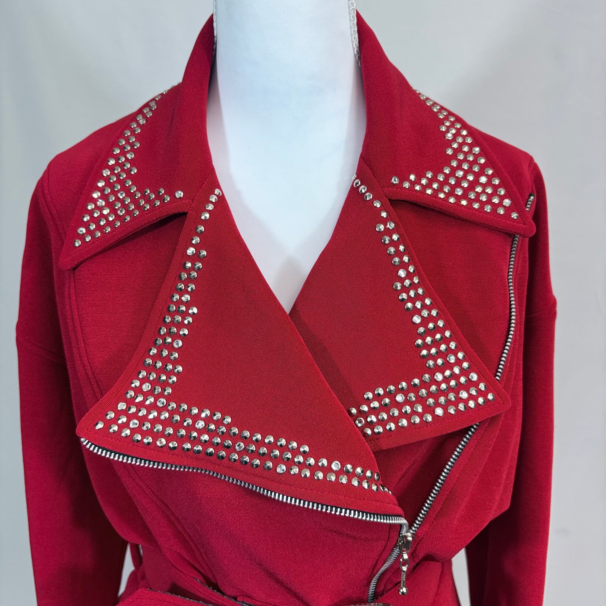 Red jacket with silver studded details on a mannequin against a white background