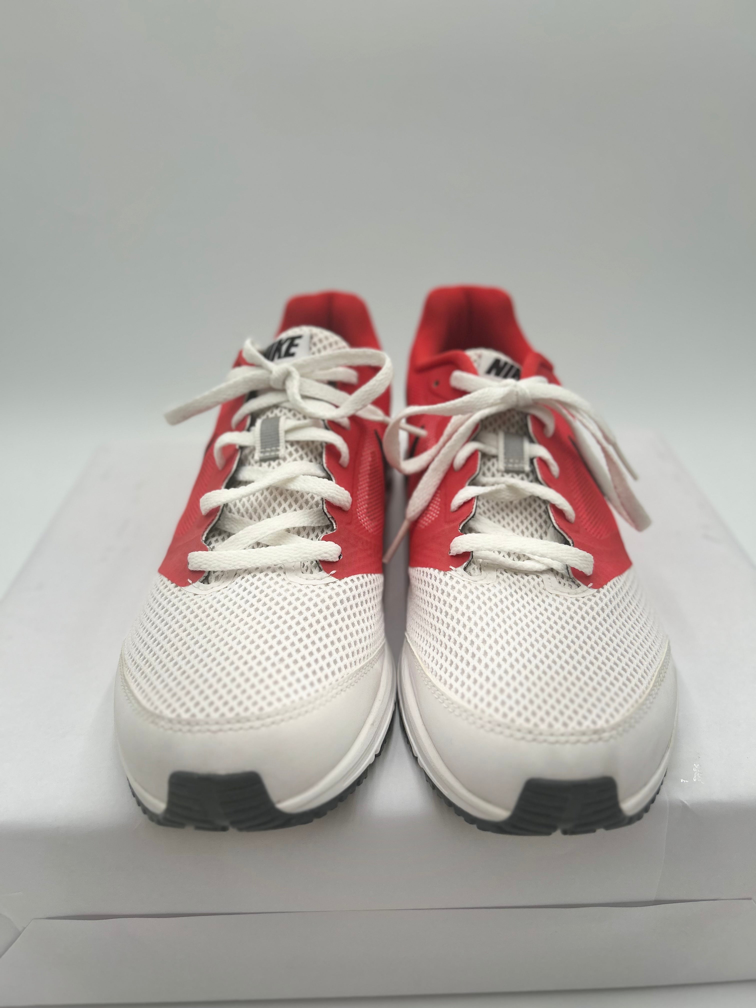 Red and white sneakers on a gray background