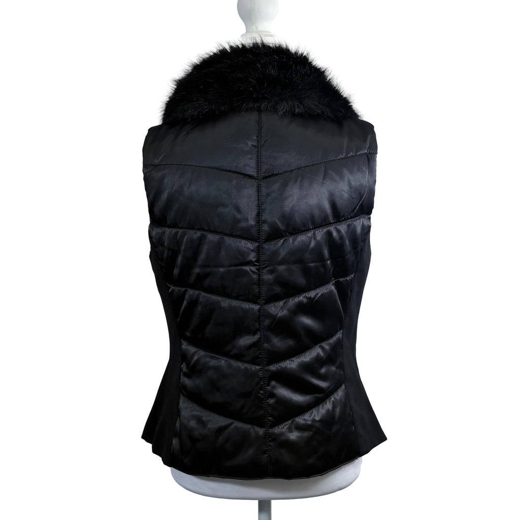 Black puffer vest with fur hood on a mannequin against a white background