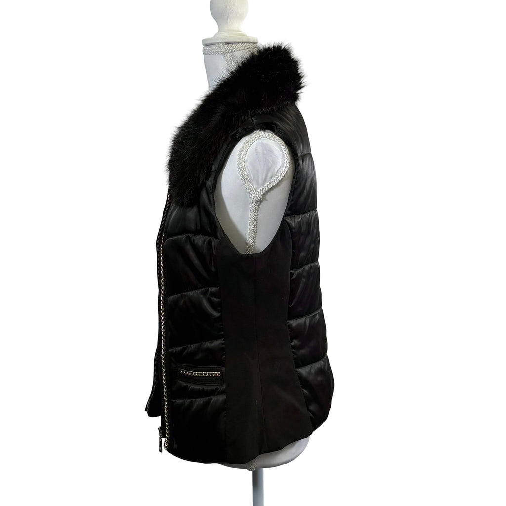 Black puffer vest with fur hood on a mannequin against a white background