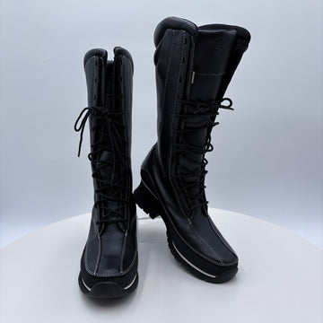 Black knee-high boots with laces on a white background