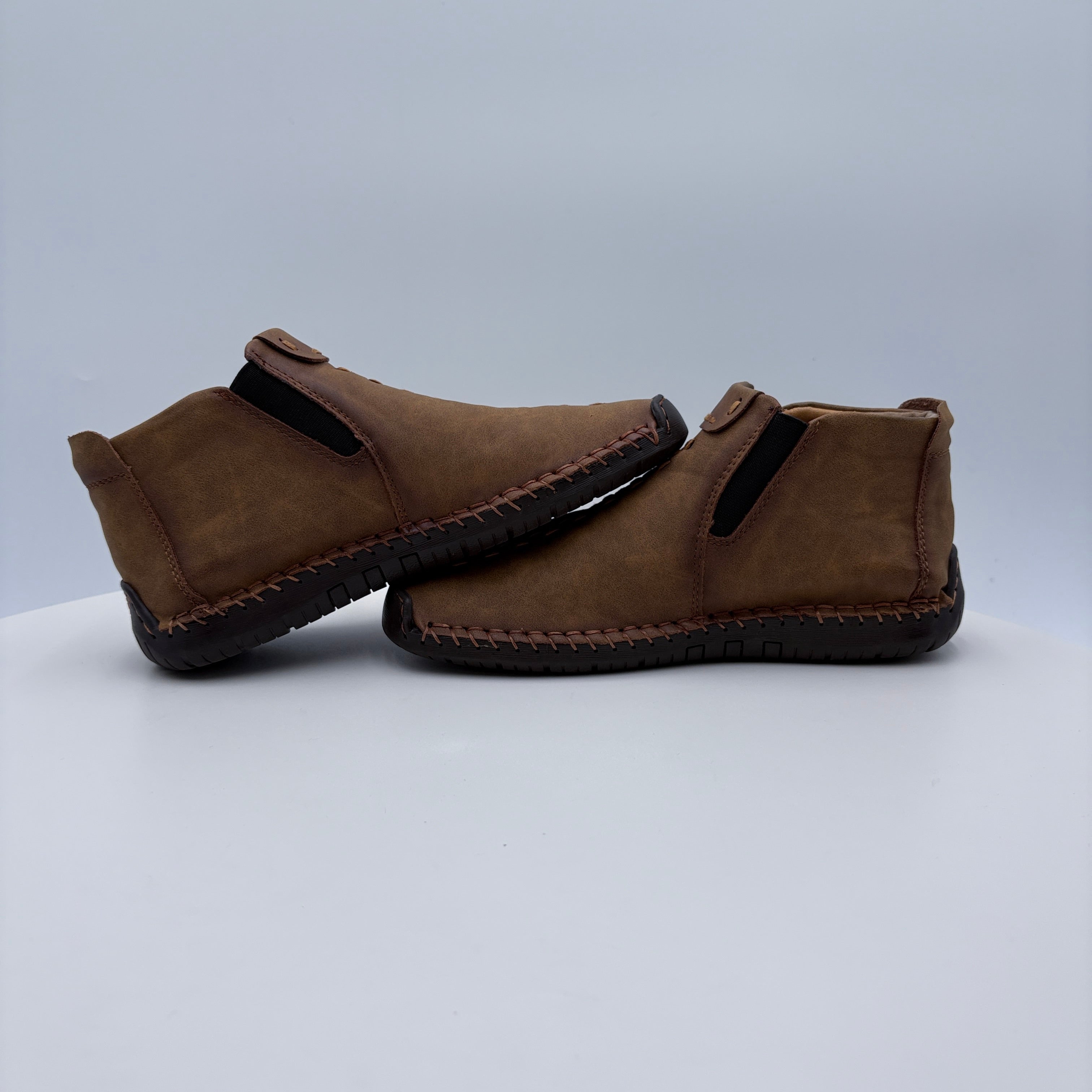Pair of brown slippers on a light gray background
