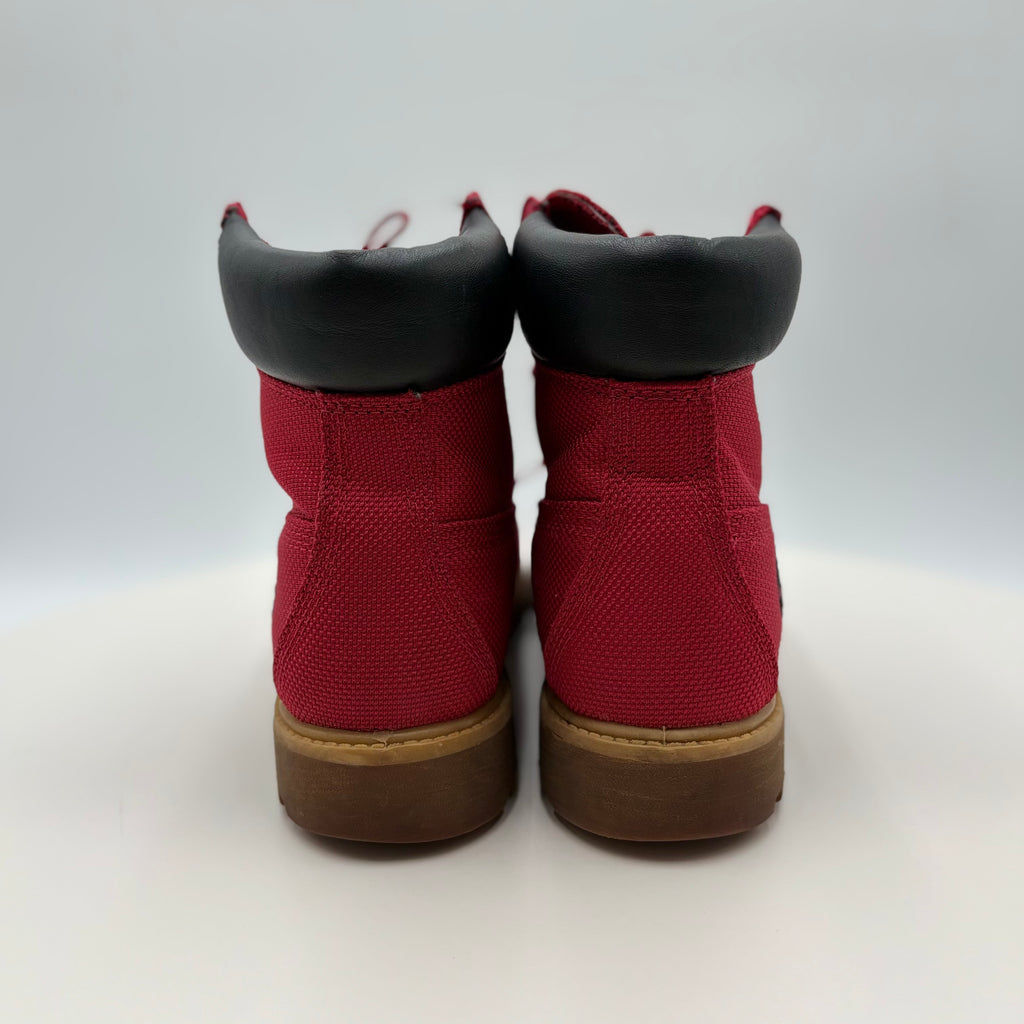 Red boots with black soles on a white background