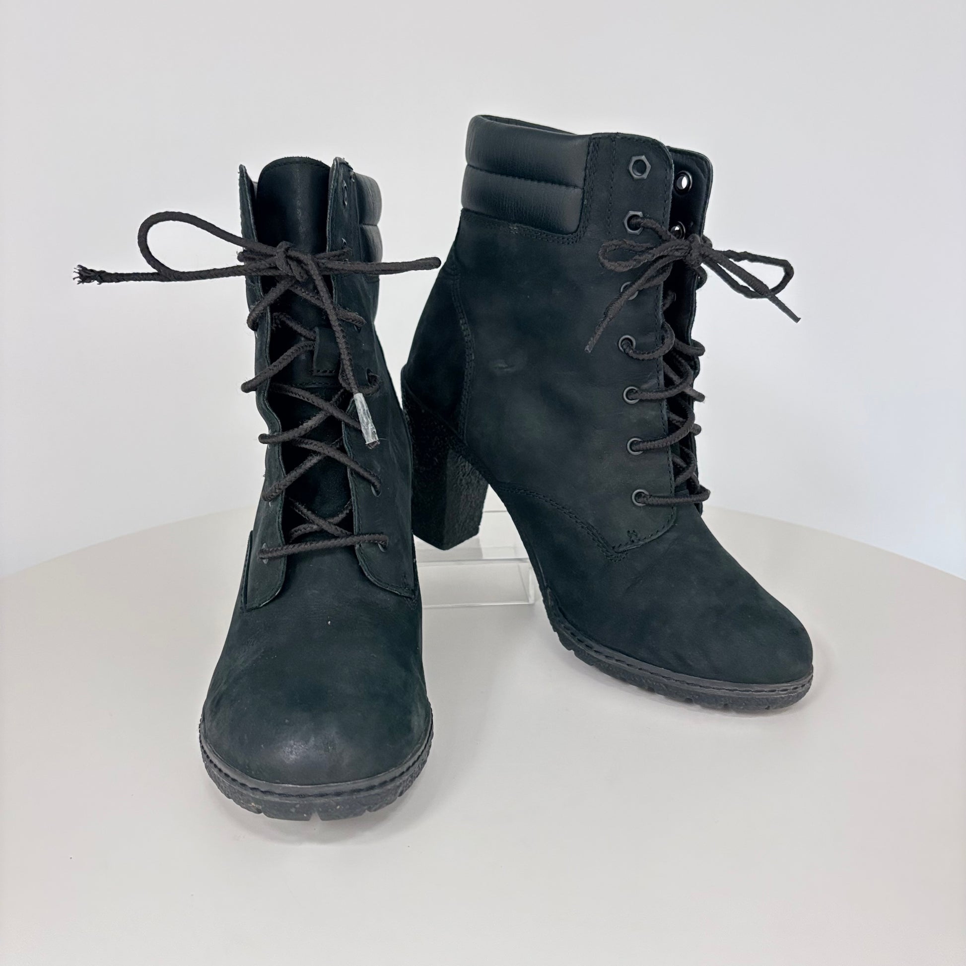 Pair of black lace-up boots on a white background
