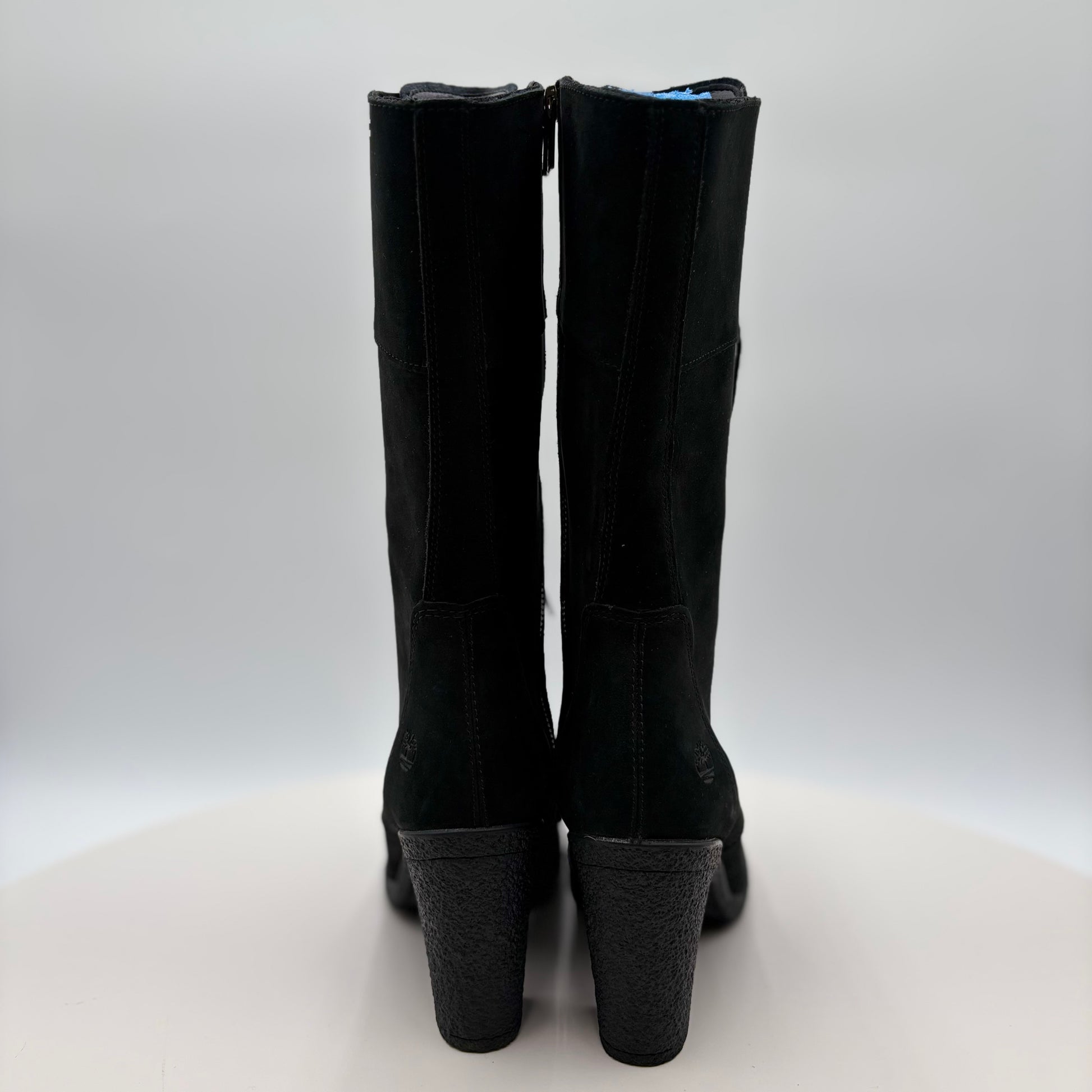 Black knee-high boots on a white background
