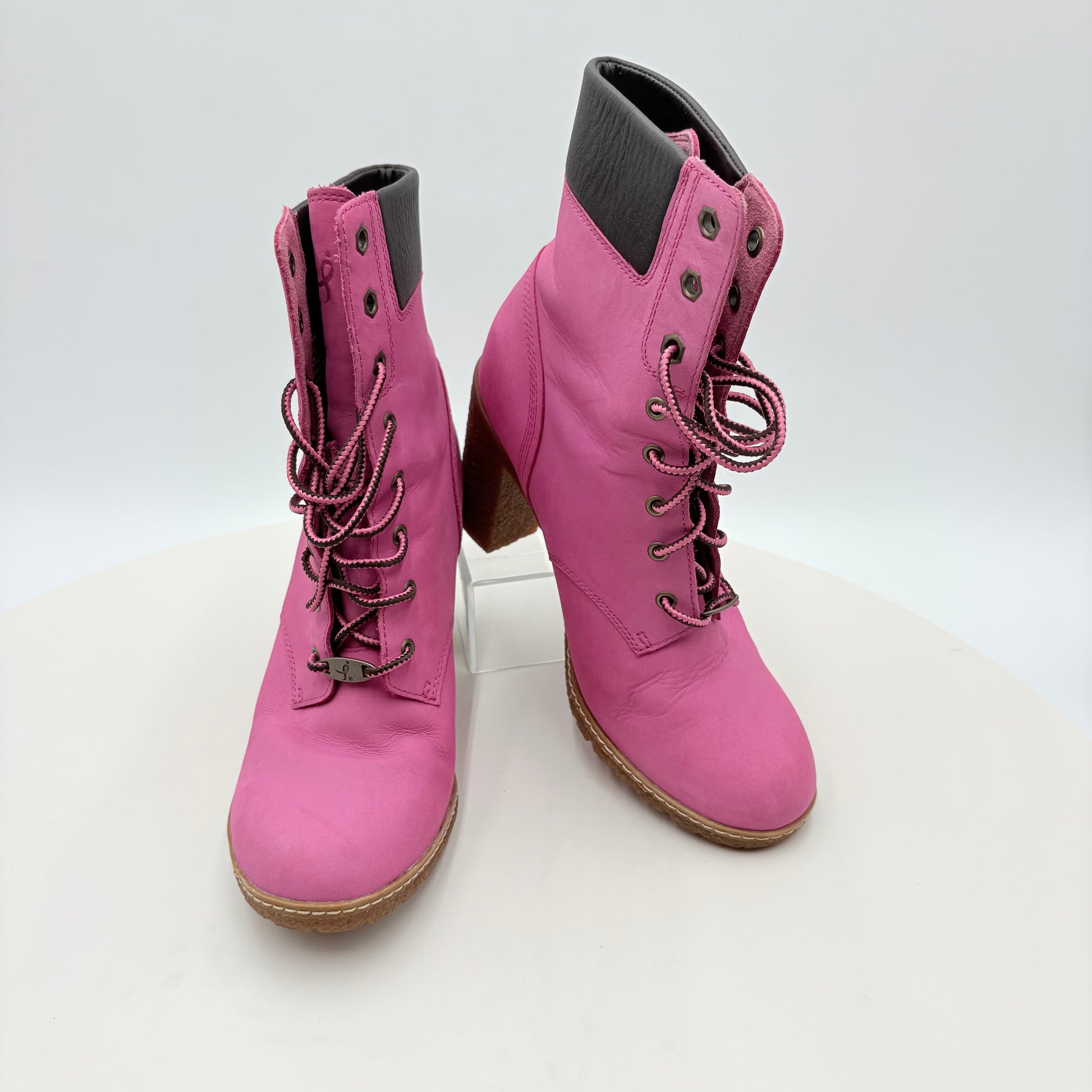 Pair of pink lace-up boots on a white background