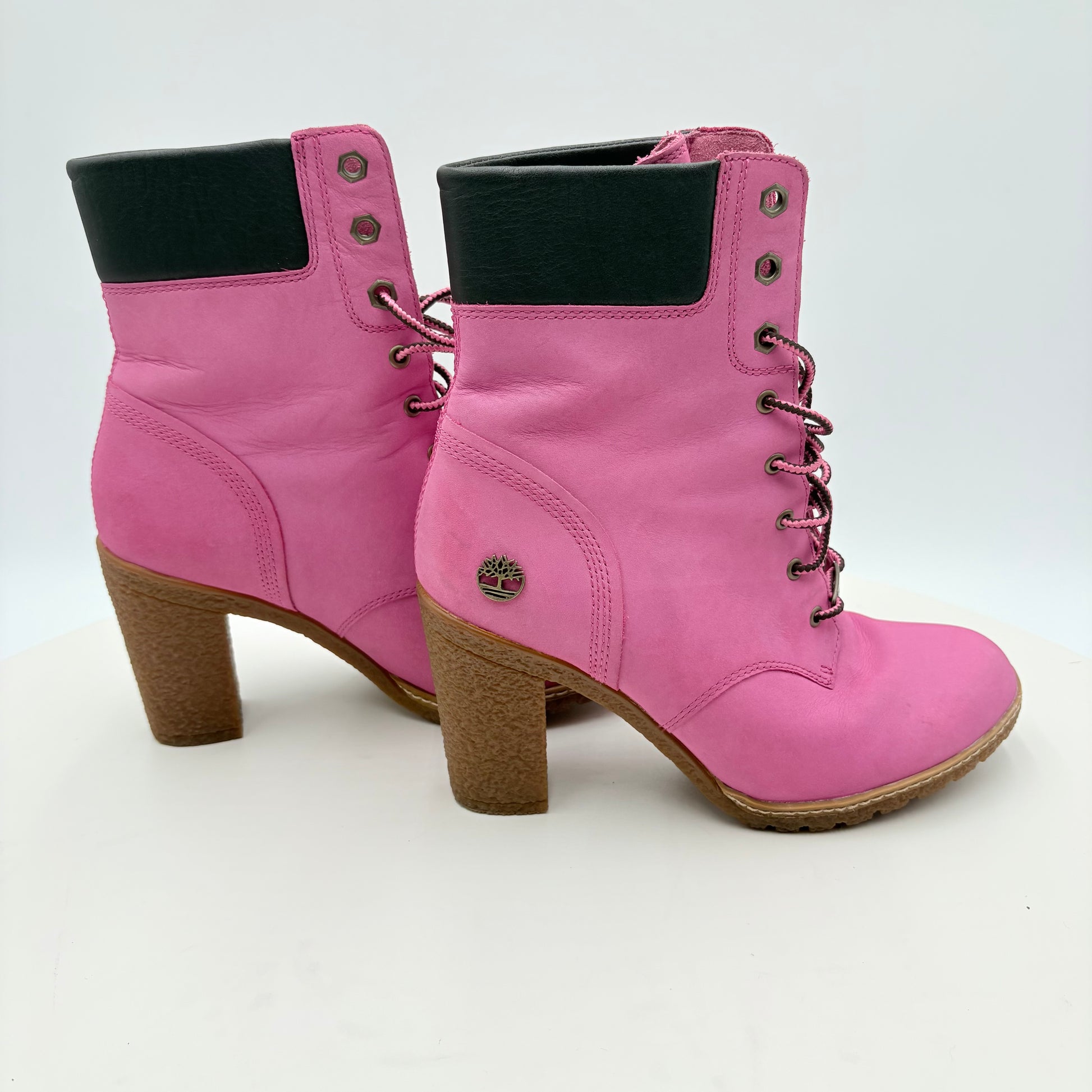 Pink boots with a brand logo on a white background