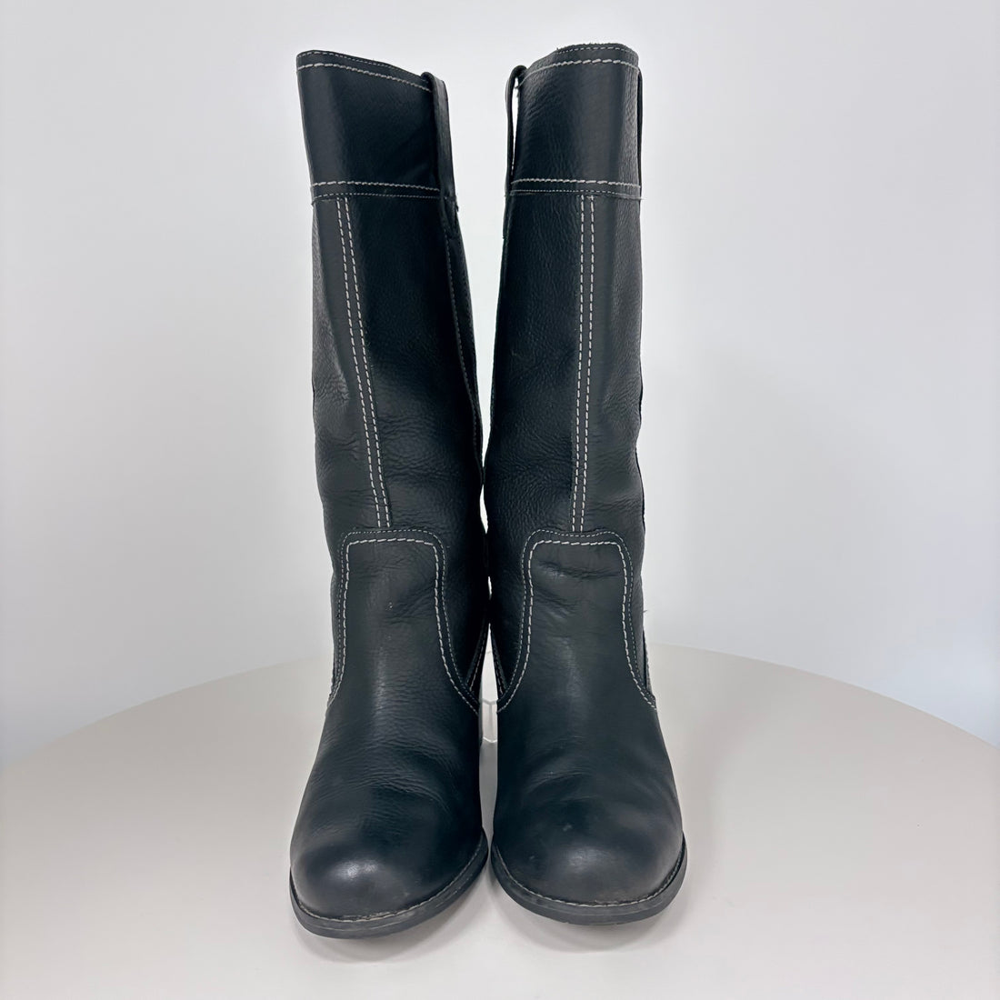 Pair of black leather boots on a white background