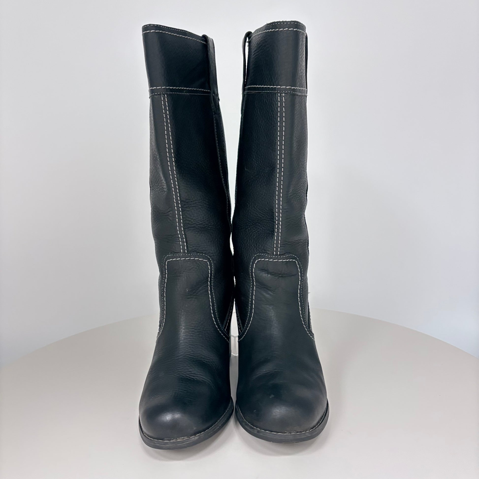 Pair of black leather boots on a white background