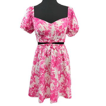 Pink and white floral dress on a mannequin against a white background