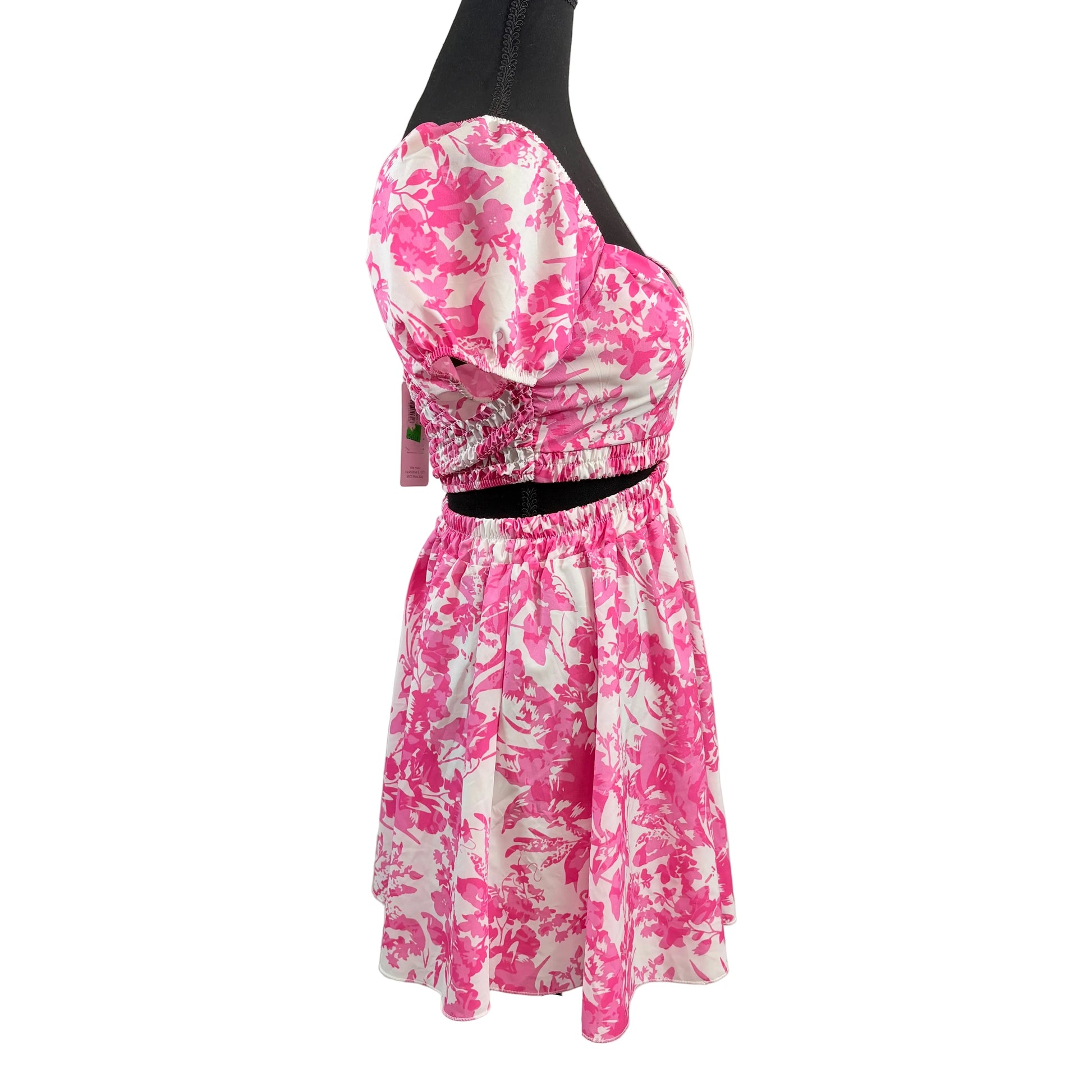 Pink floral dress on a mannequin against a white background