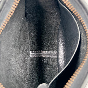 Close-up of a black leather bag with gold zipper