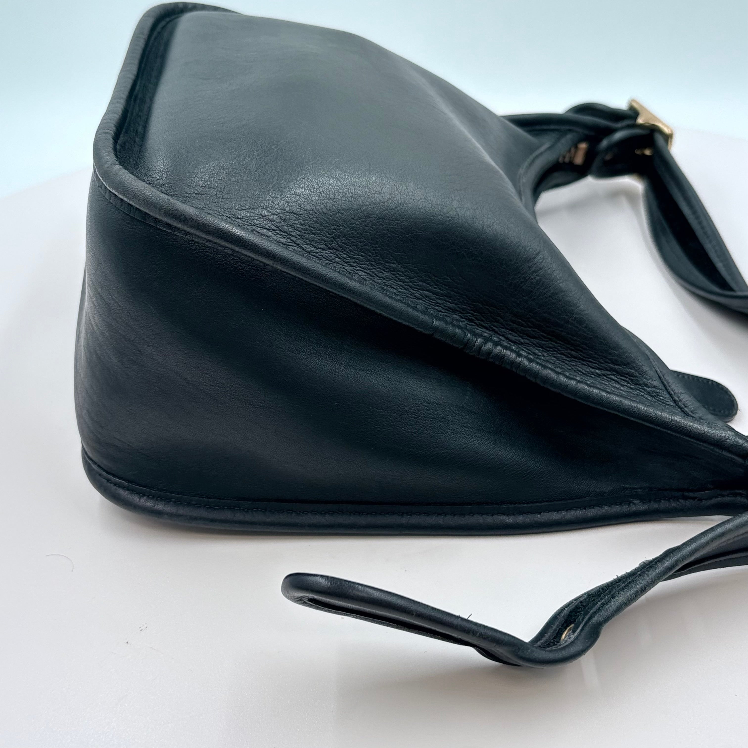 Black leather handbag on a white background