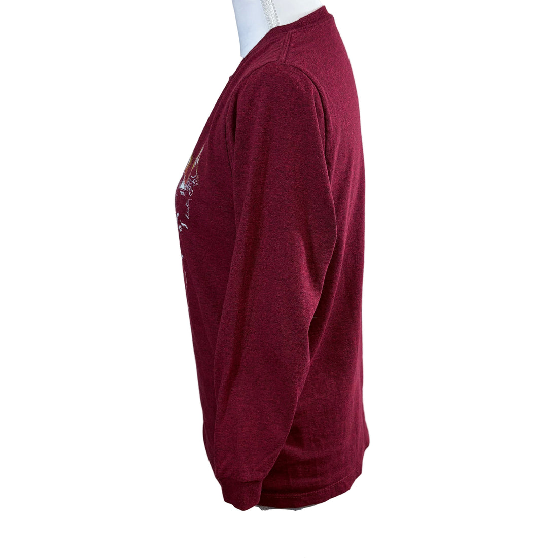Maroon long-sleeve shirt with Kiss graphic design on a mannequin against a white background