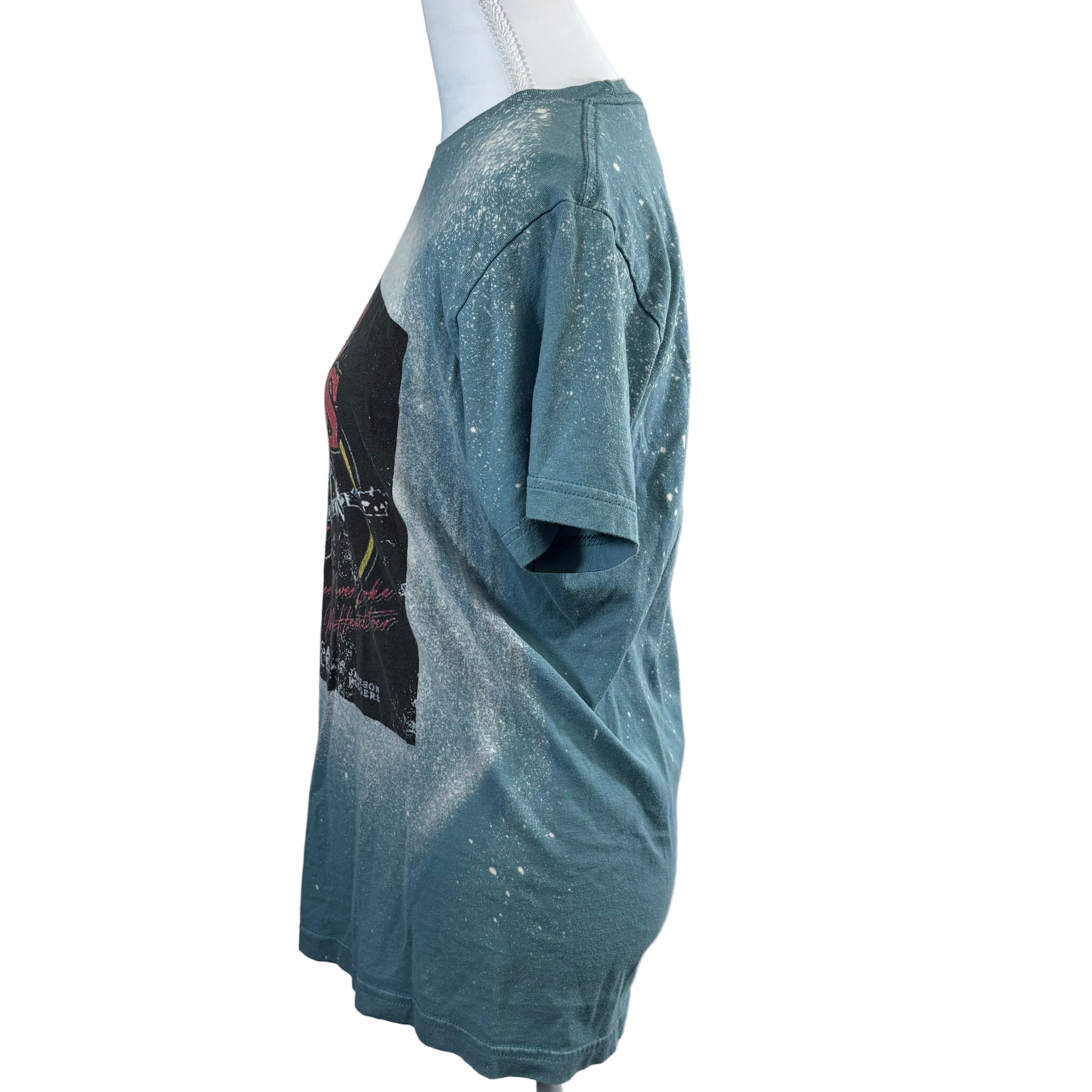 Blue t-shirt with graphic design on a mannequin against a gray background