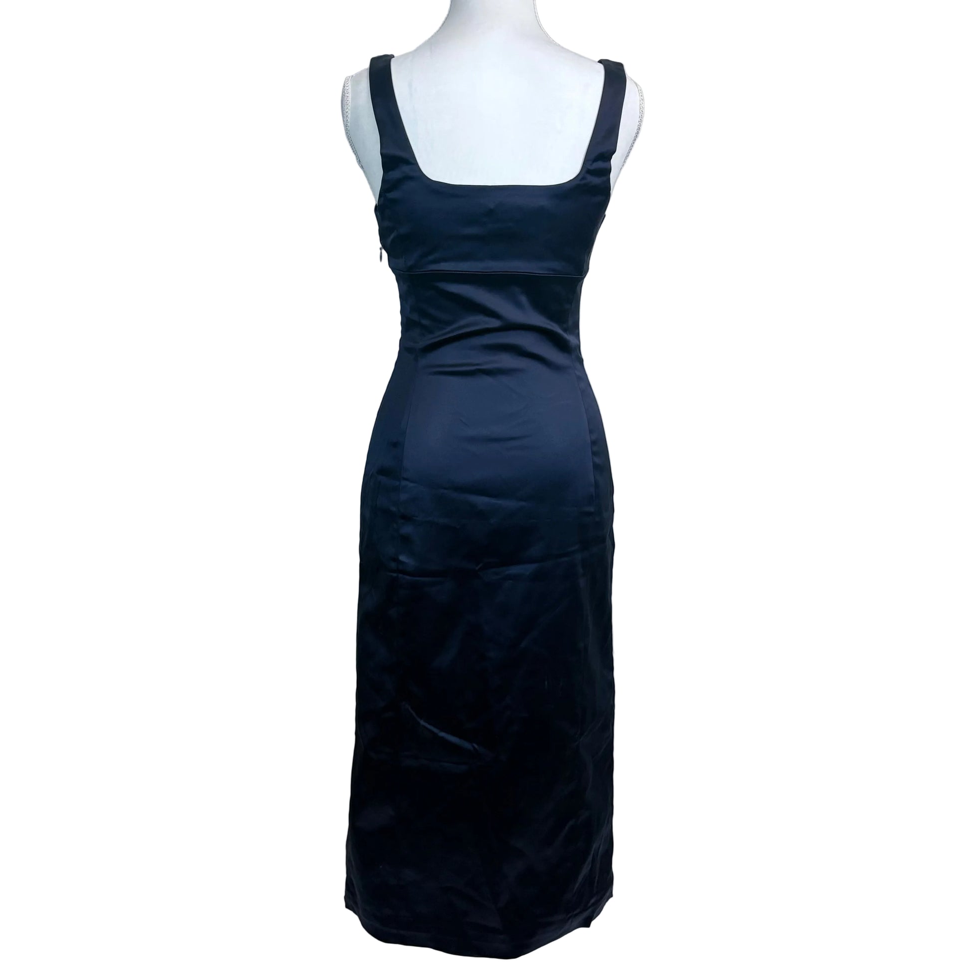 Navy blue evening gown on a mannequin against a plain background